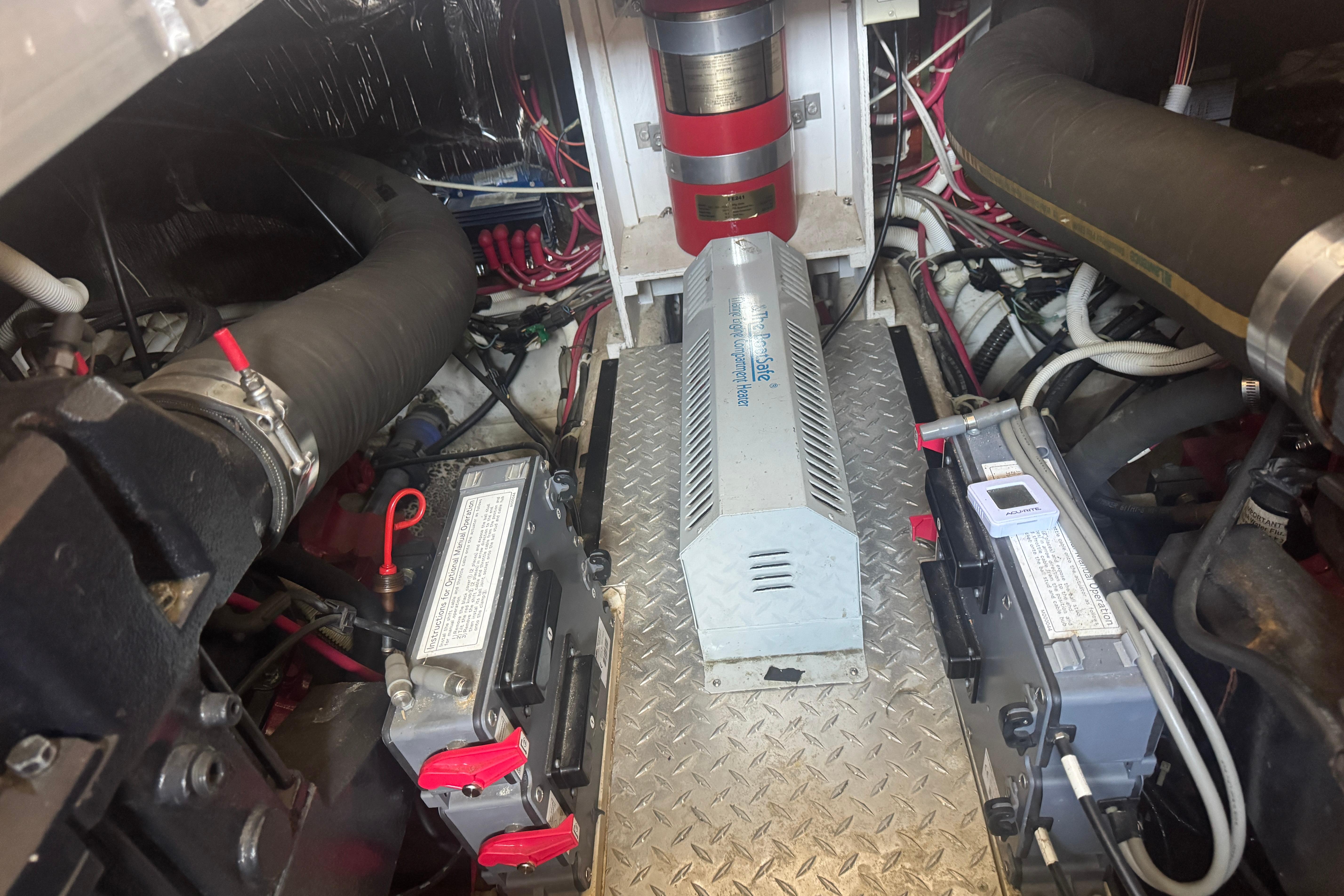 Engine room of a 2002 Carver 396 Motor Yacht, featuring batteries and wiring.