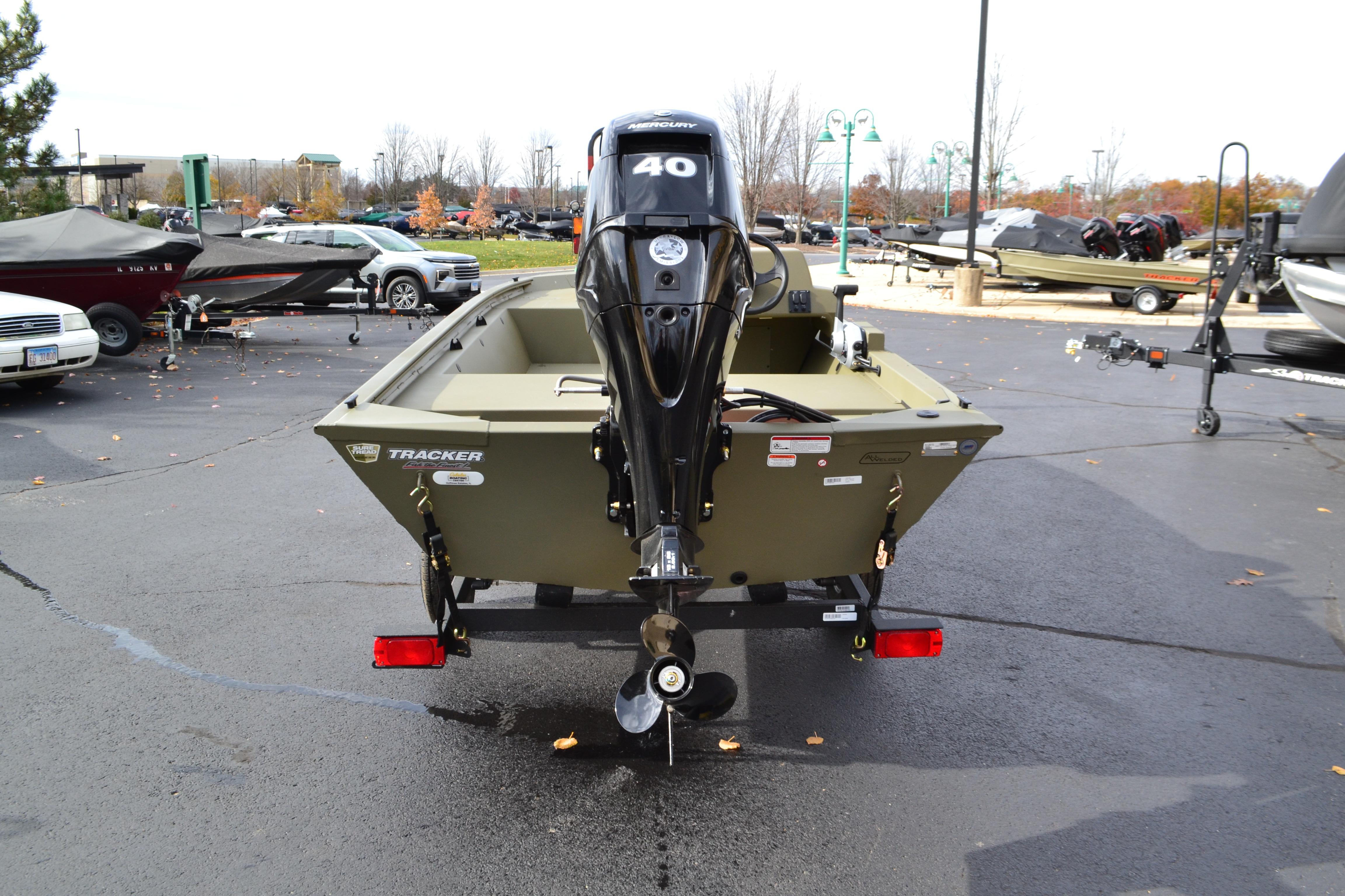 2026 Tracker Grizzly 1648 SC boat with 40 HP motor in a parking lot.