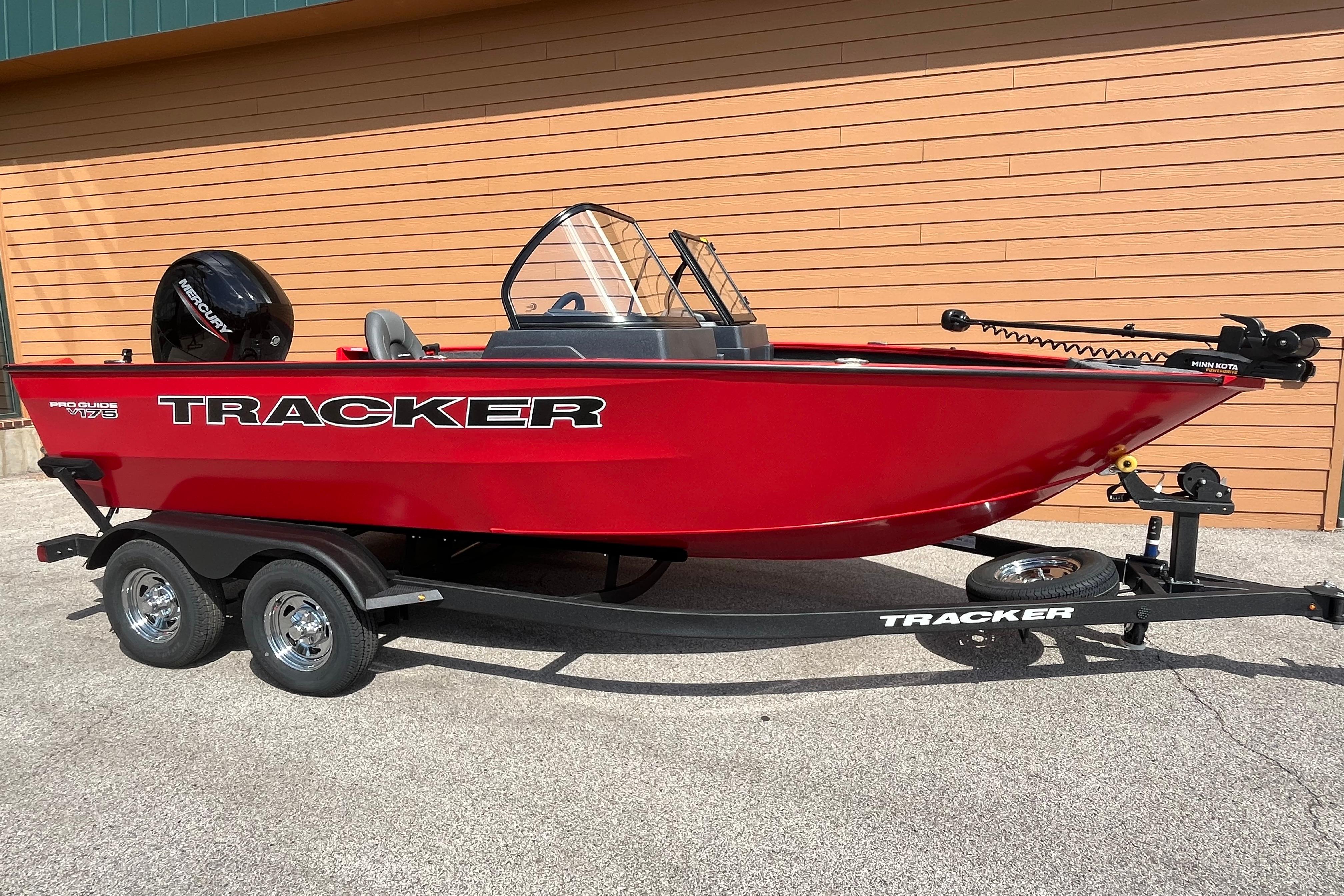 2026 Tracker Pro Guide V-175 Combo boat, red, on trailer, parked outdoors.