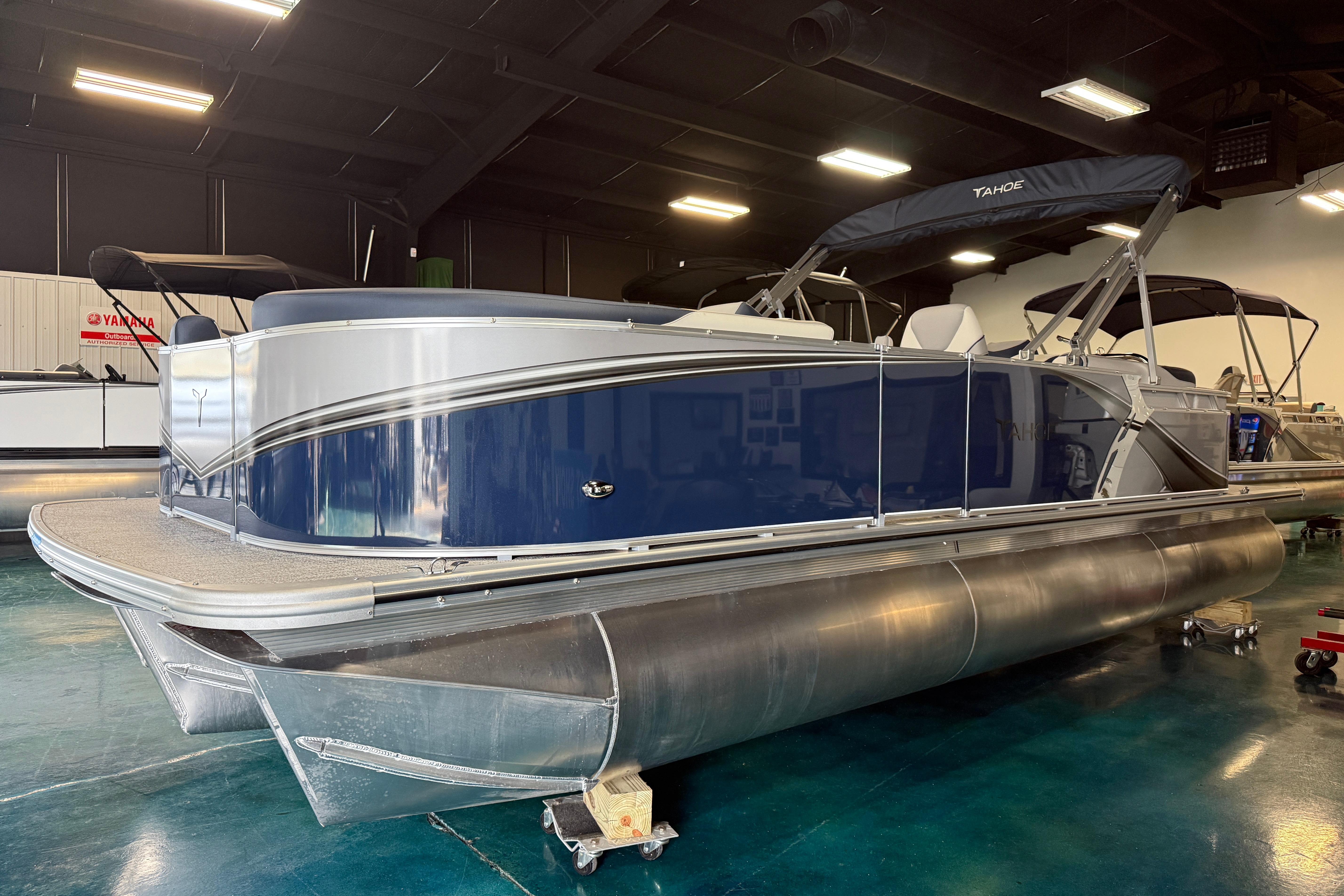 2026 Tahoe Pontoon LTZ Quad Lounger in showroom, featuring sleek design and modern amenities.