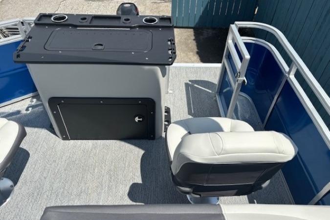 2026 Sun Tracker Fishin' Barge 20 DLX interior with seating and control panel.