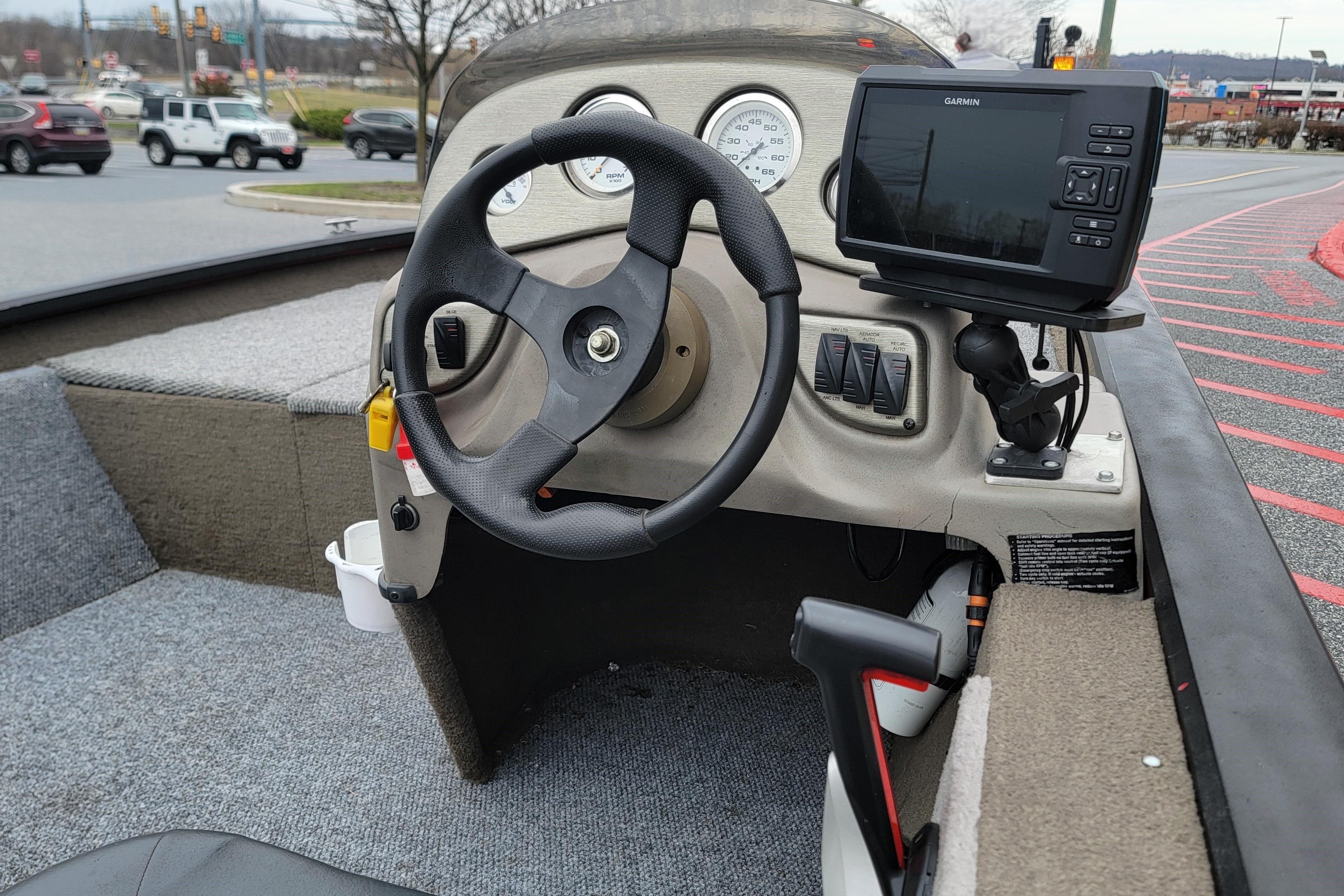2006 Tracker Pro Team 190 TX boat dashboard with steering wheel and Garmin GPS.