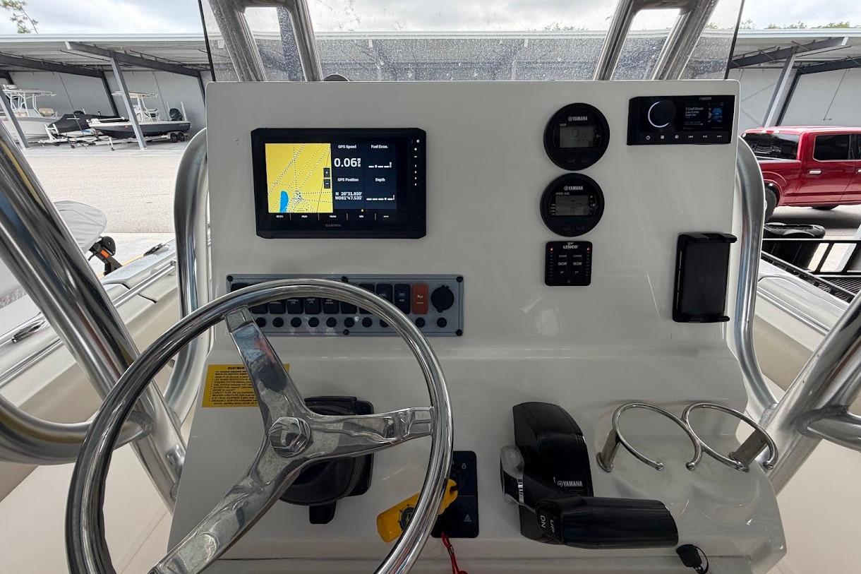 2024 Key West 219 FS boat dashboard with GPS, controls, and steering wheel.
