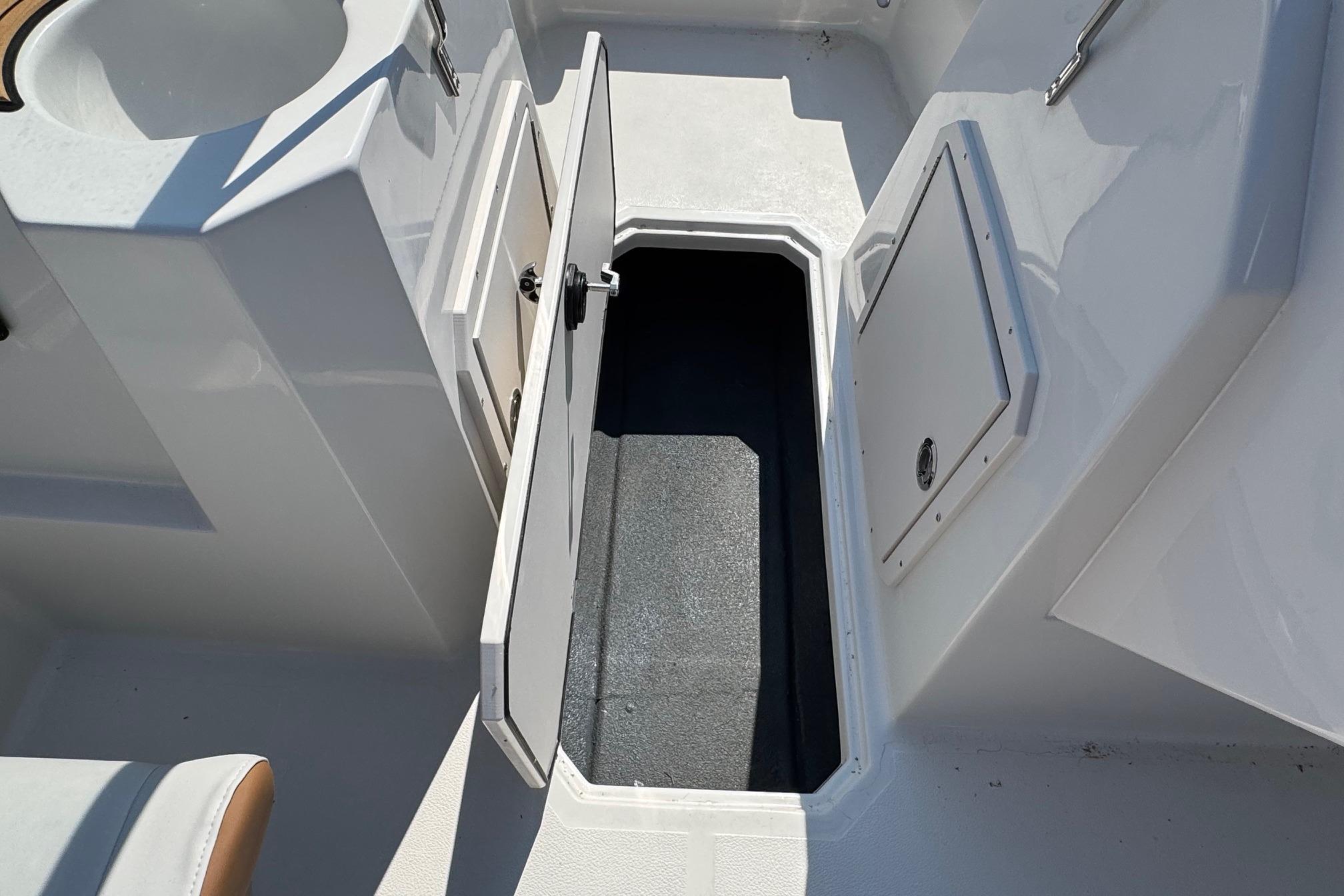 Open storage compartment on 2026 Starcraft SVX 190 OB boat deck.