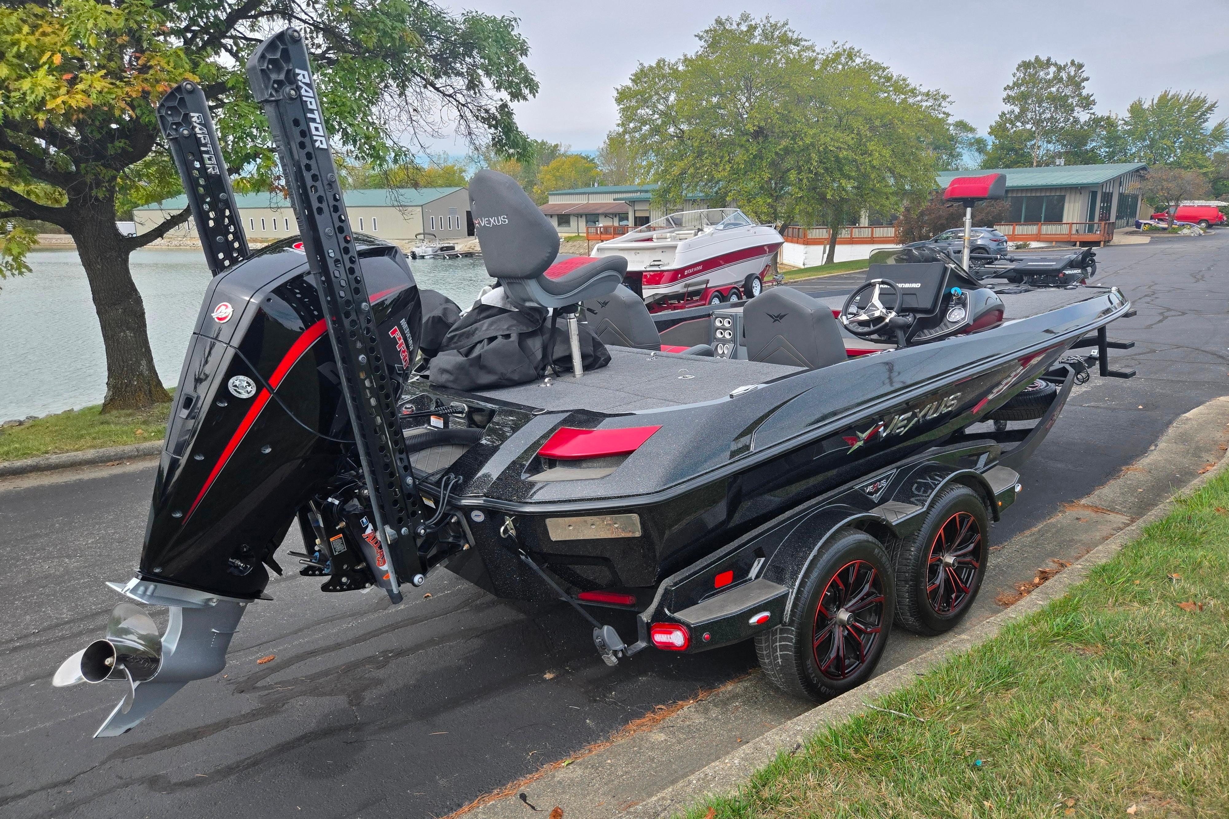 2022 Vexus VX20 boat with dual power poles, parked near a lake.
