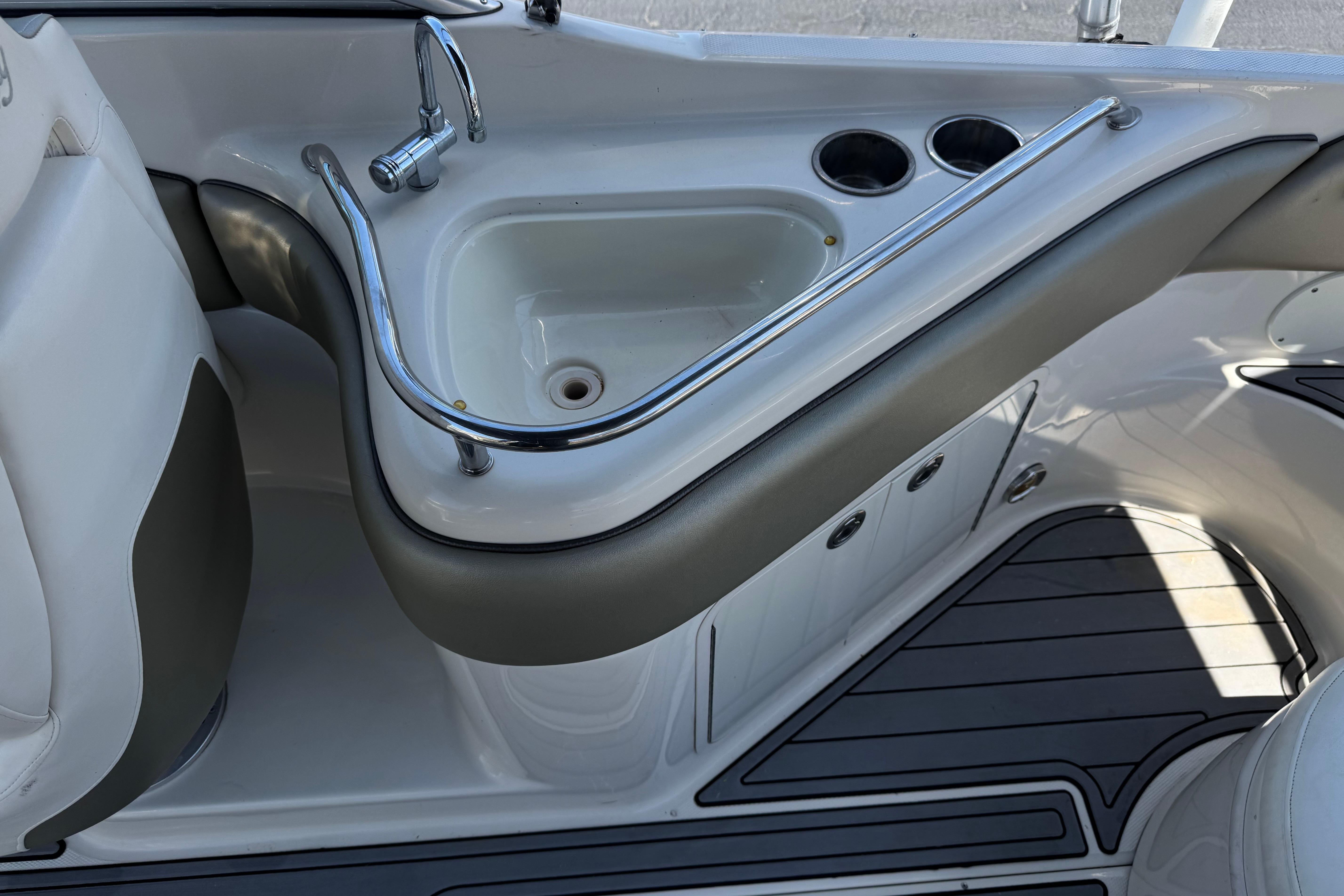 2007 Sea Ray 240 Sundeck boat interior with sink and cup holders.