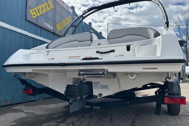2026 Yamaha Boats AR190 on trailer, rear view, parked near blue building.
