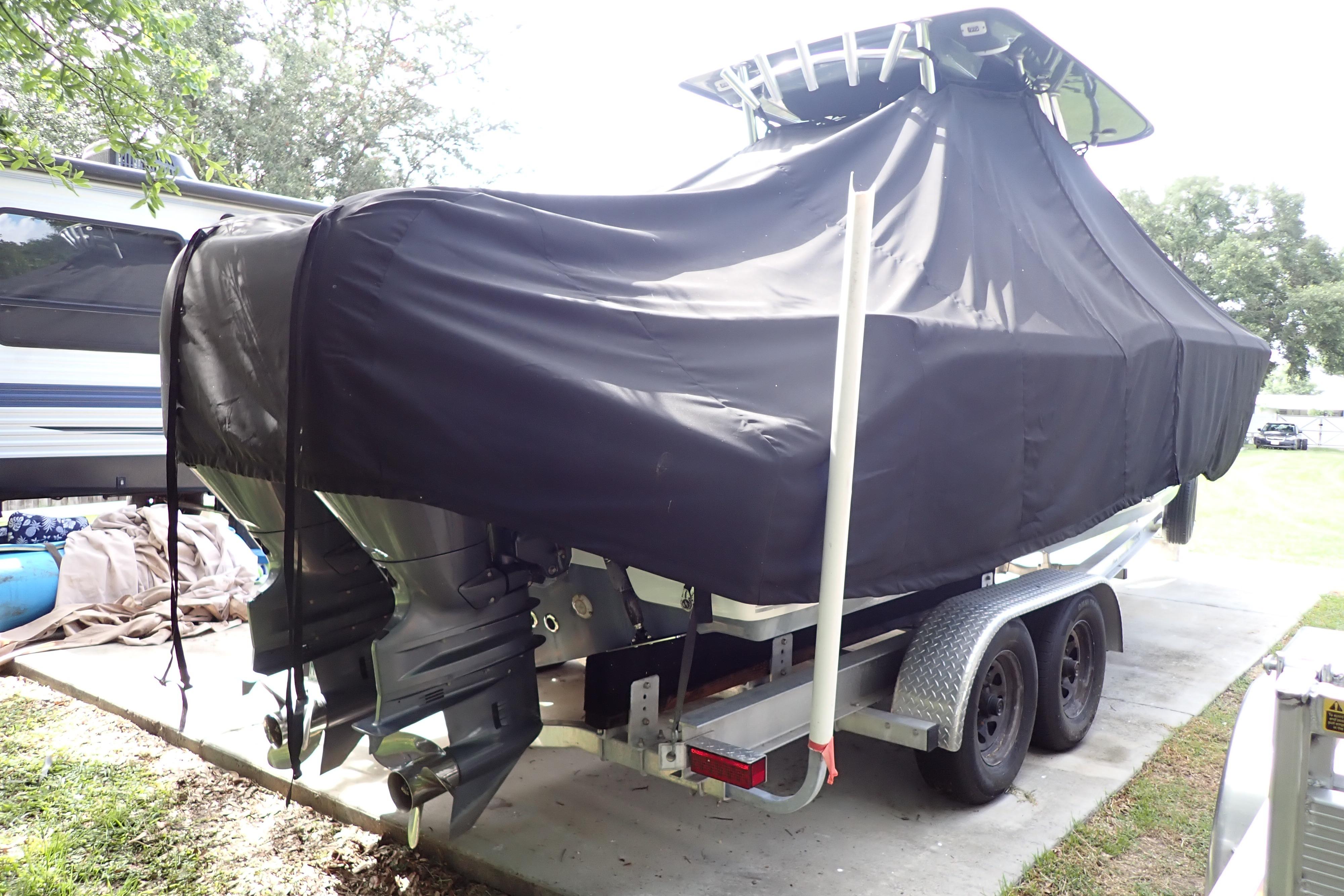 2019 Key West 263 FS boat covered on a trailer, parked outdoors.