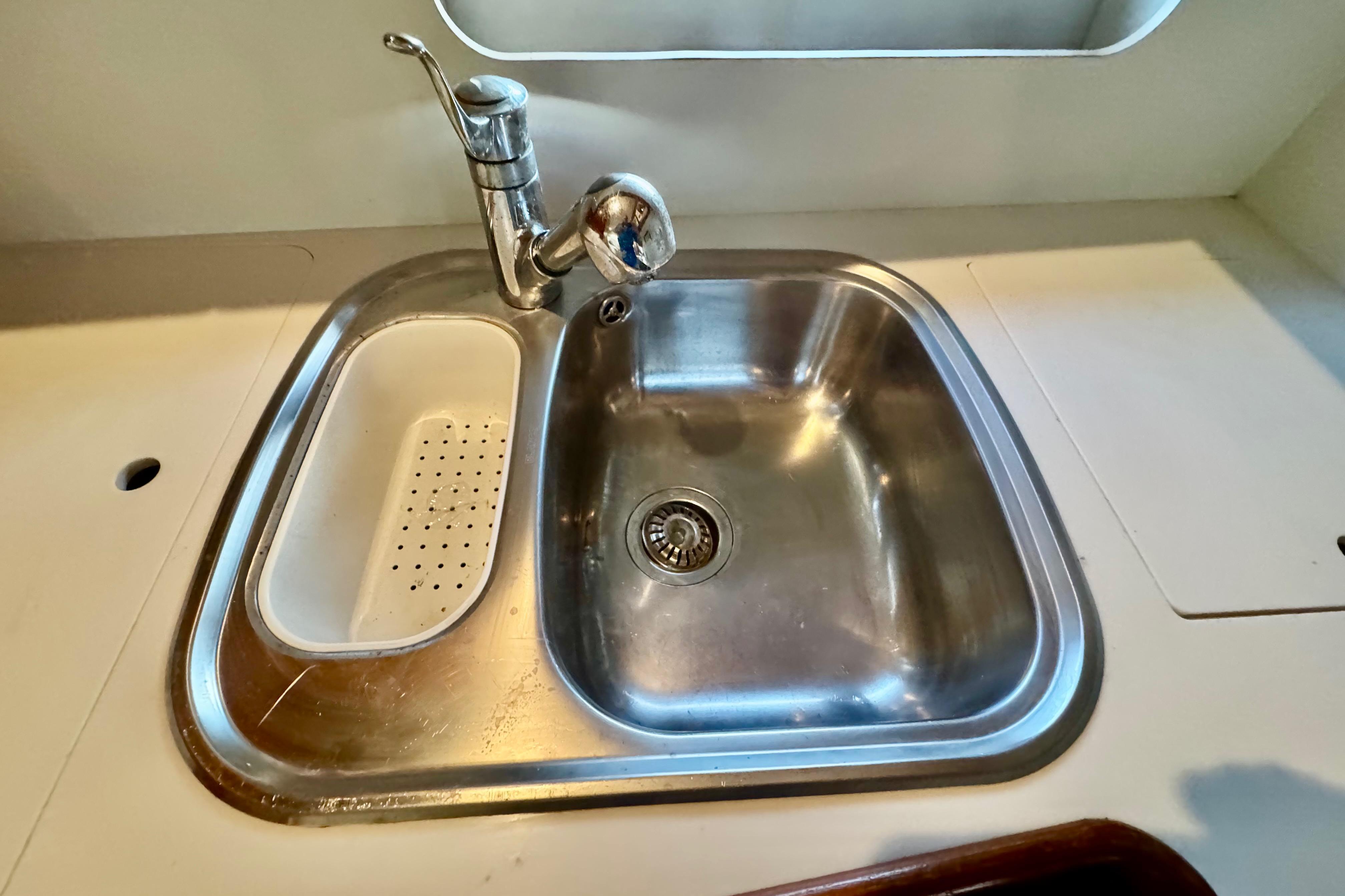 Stainless steel sink with faucet in 2000 Tiara 37 Open boat kitchen.