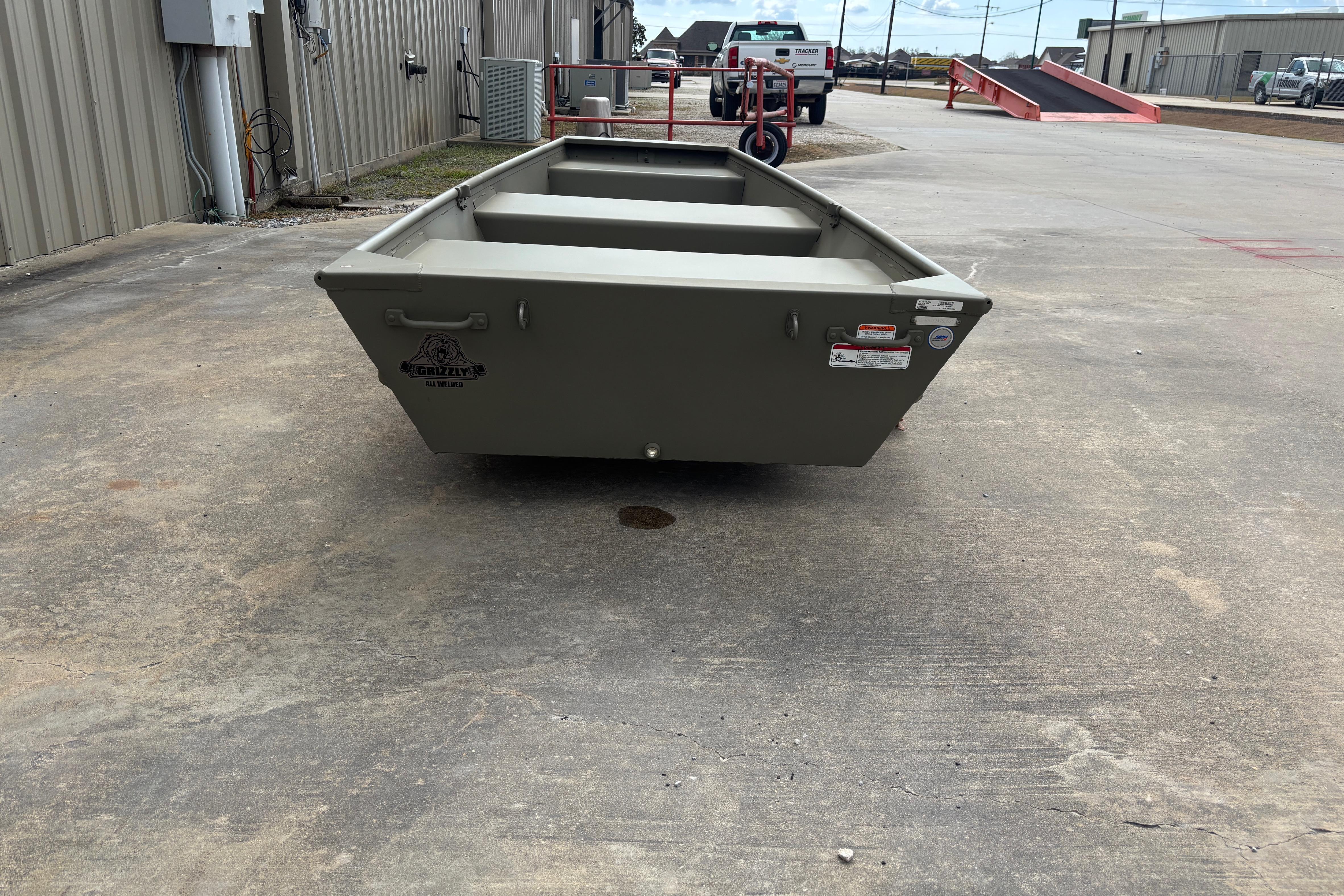 2026 Tracker Grizzly 10 Jon boat on concrete surface, industrial background.