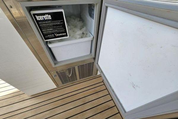 Ice maker on 2005 Sunseeker Manhattan 66 yacht with wooden deck flooring.