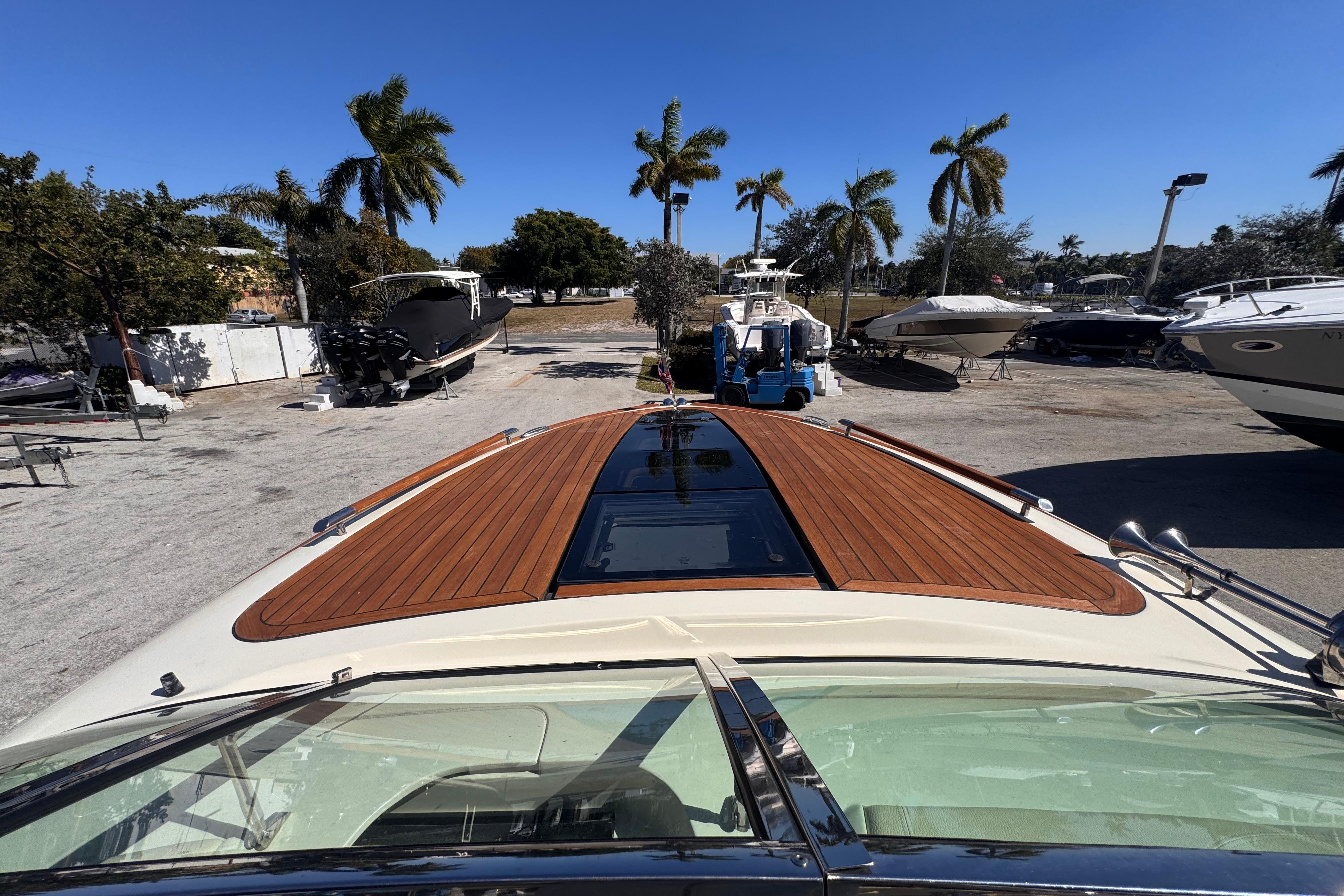 2019 Chris-Craft Corsair 30 with teak deck, parked under clear blue sky.