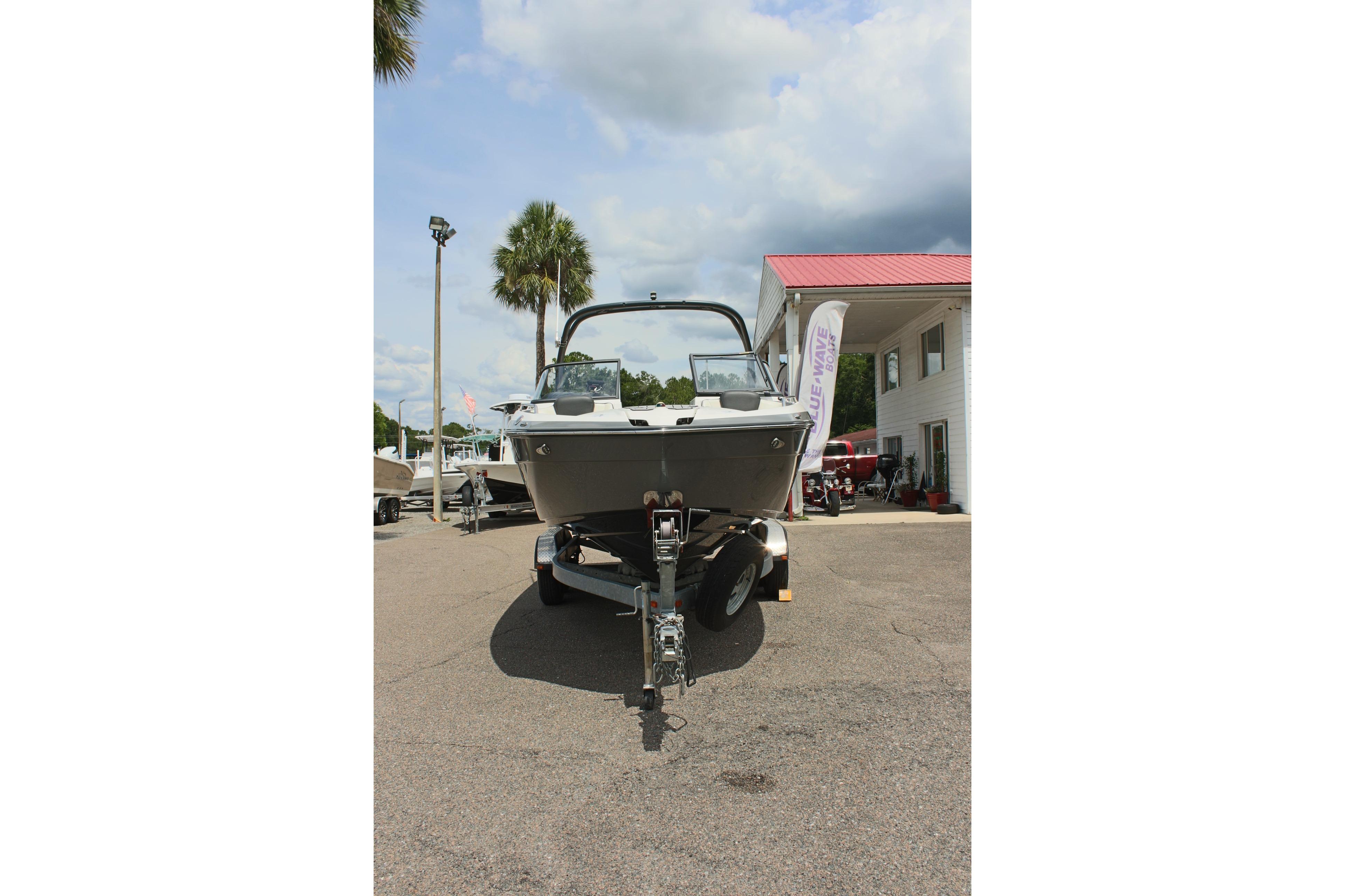 2016 Yamaha Boats 242 Limited S on trailer, parked outdoors near dealership.