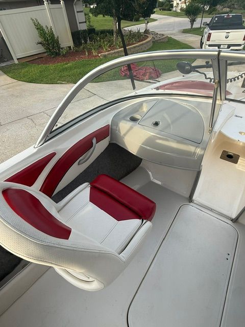 Interior of a 2012 Bayliner 184 SF boat with red and white seating.