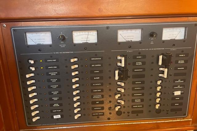 Electrical control panel on a 2001 Tartan 3700 yacht, featuring switches and gauges.