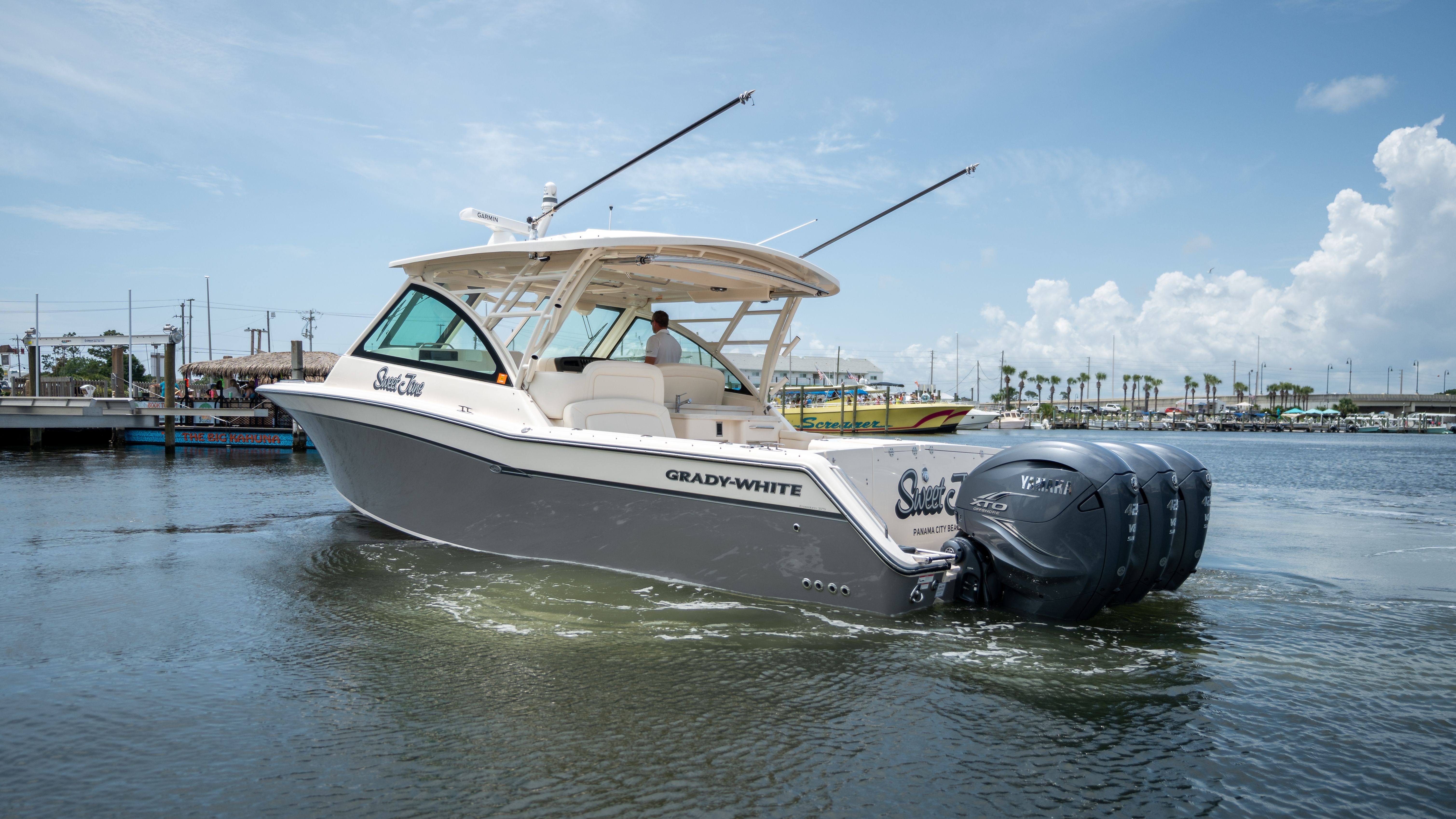 2019 Grady-White 375 Freedom on the water with three outboard engines.