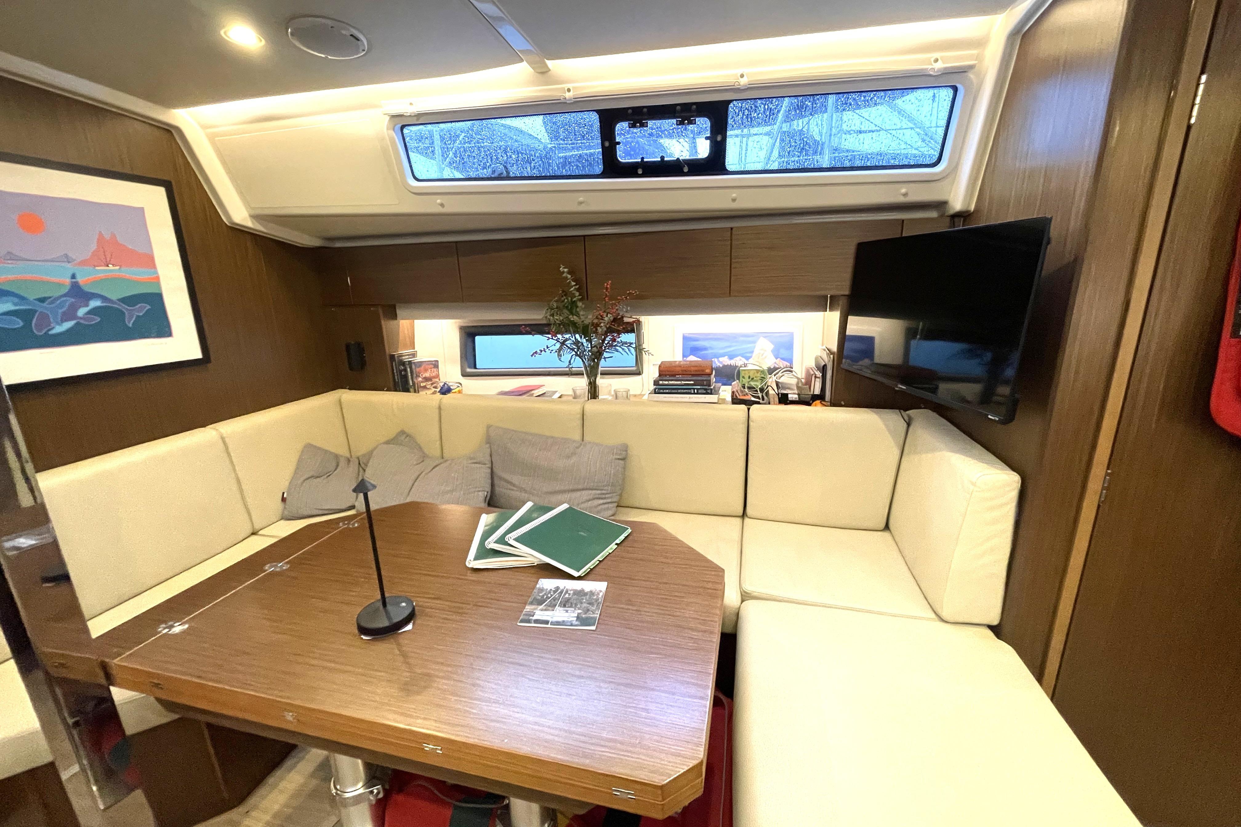Interior of 2021 Bavaria C42 yacht with cozy seating and modern decor.