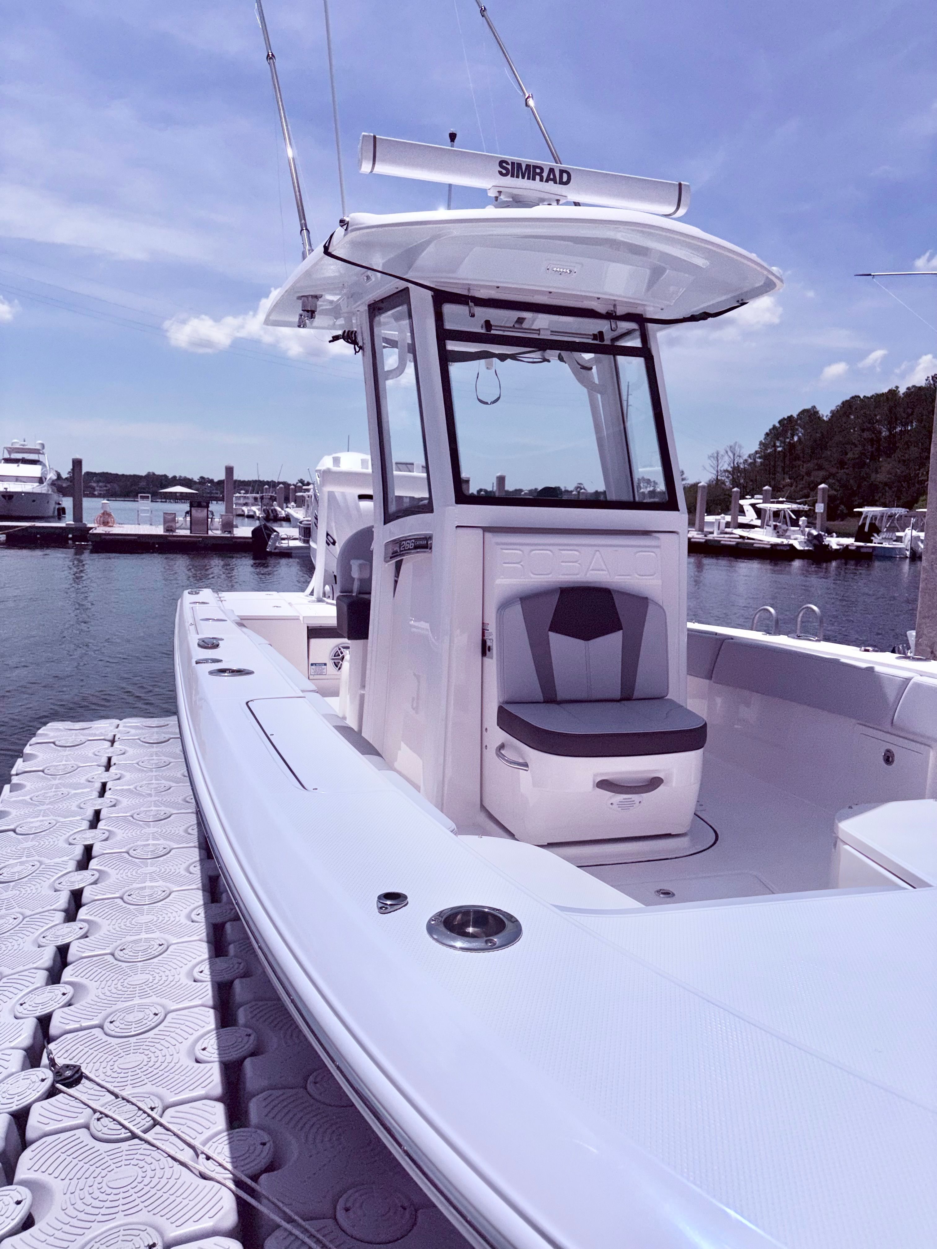 2025 Robalo 266 Cayman boat docked on a sunny day.