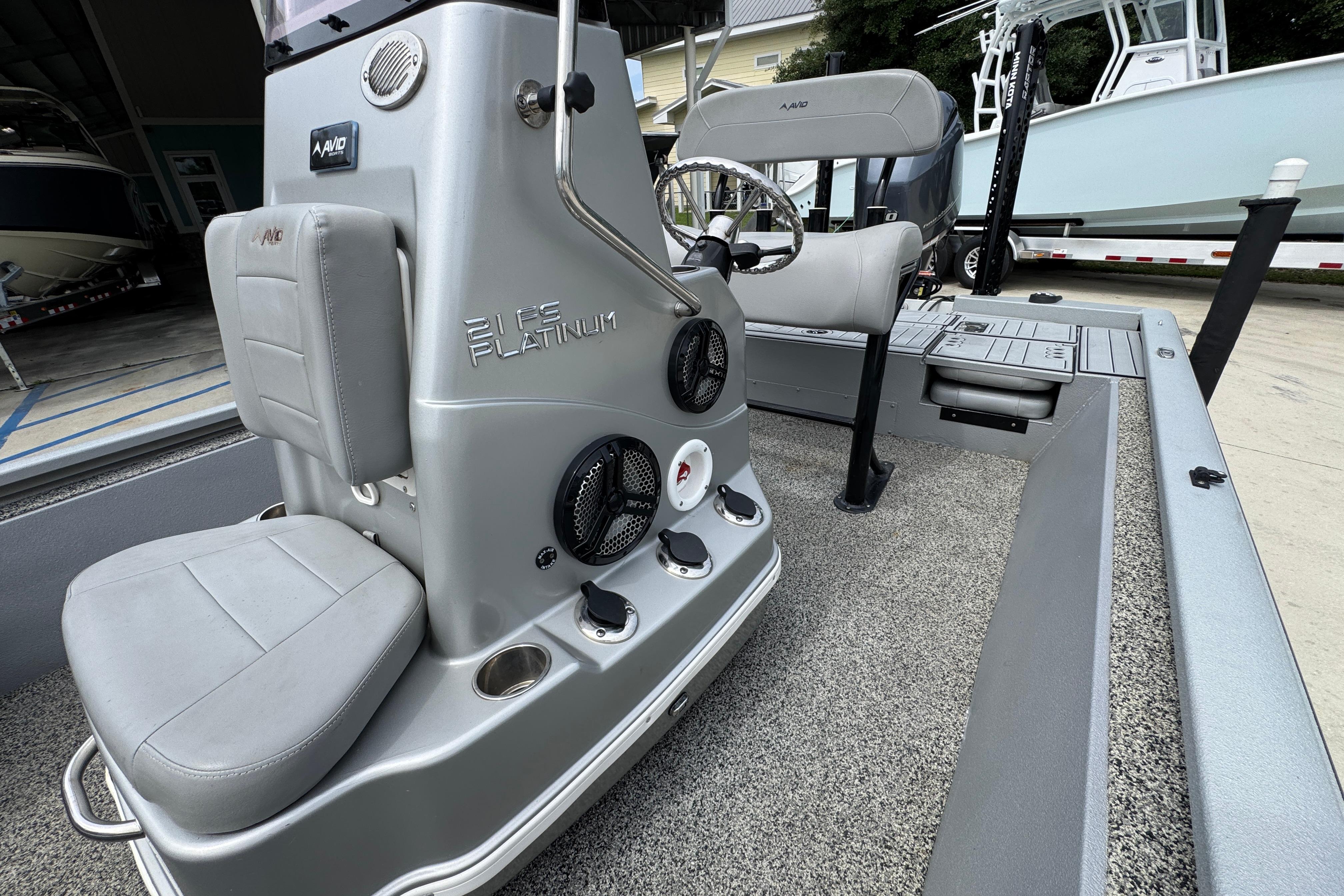 2021 Avid 21 FS boat interior with steering console and seating.