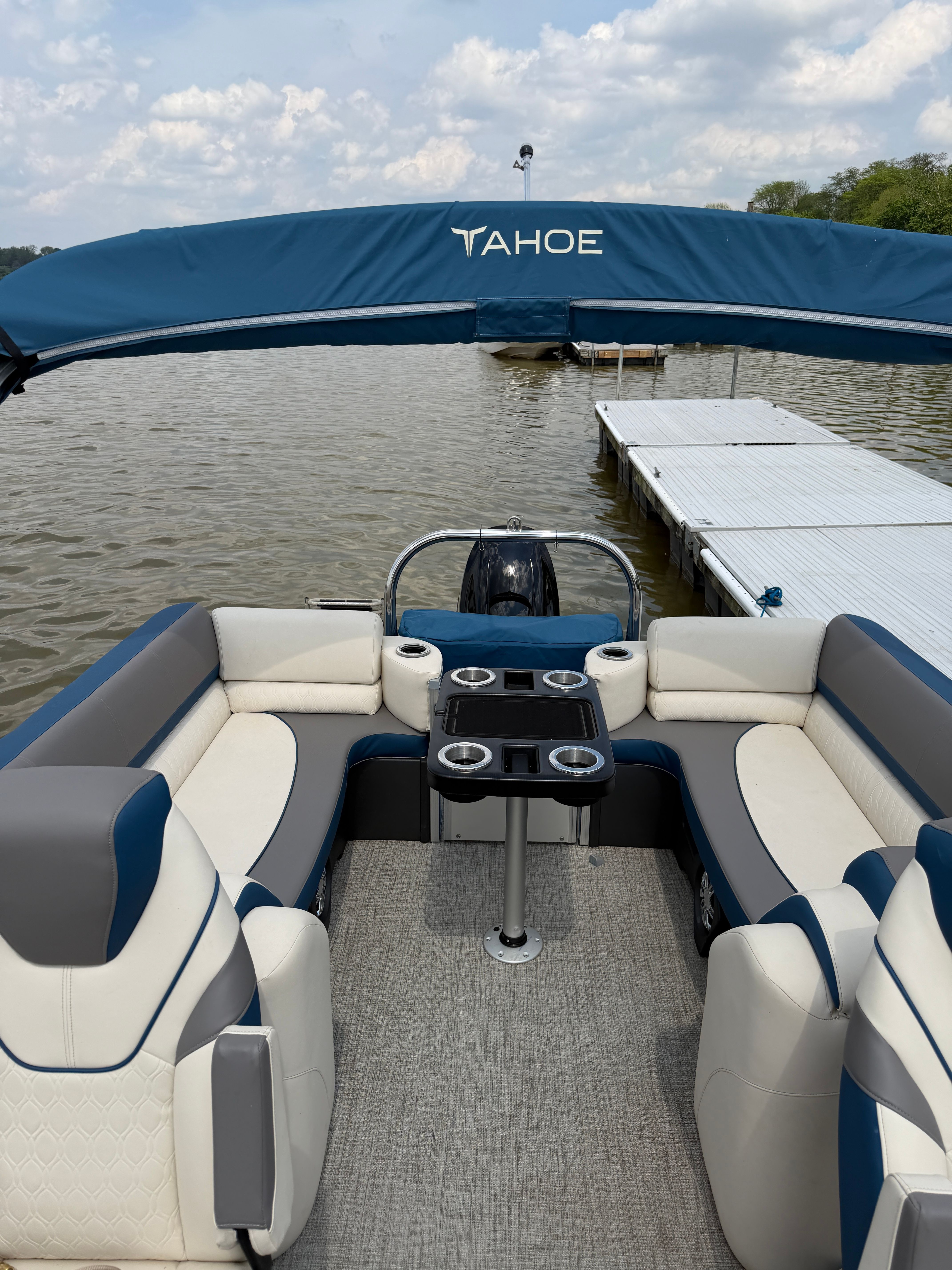 2024 Tahoe Pontoon Cascade Quad Lounger on a lake with dock.