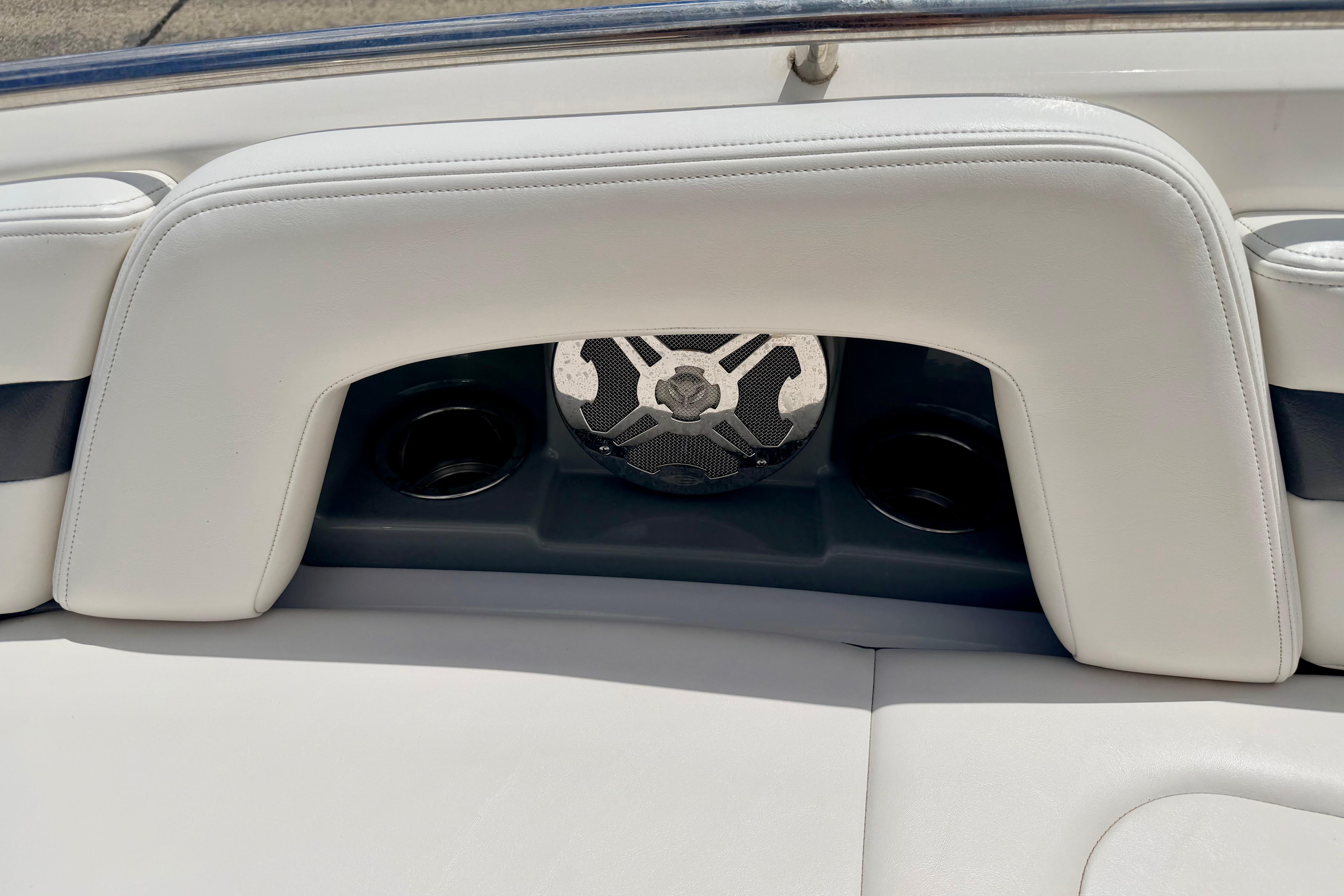 2015 Chaparral Sunesta 264 boat interior with white seating and speaker system.