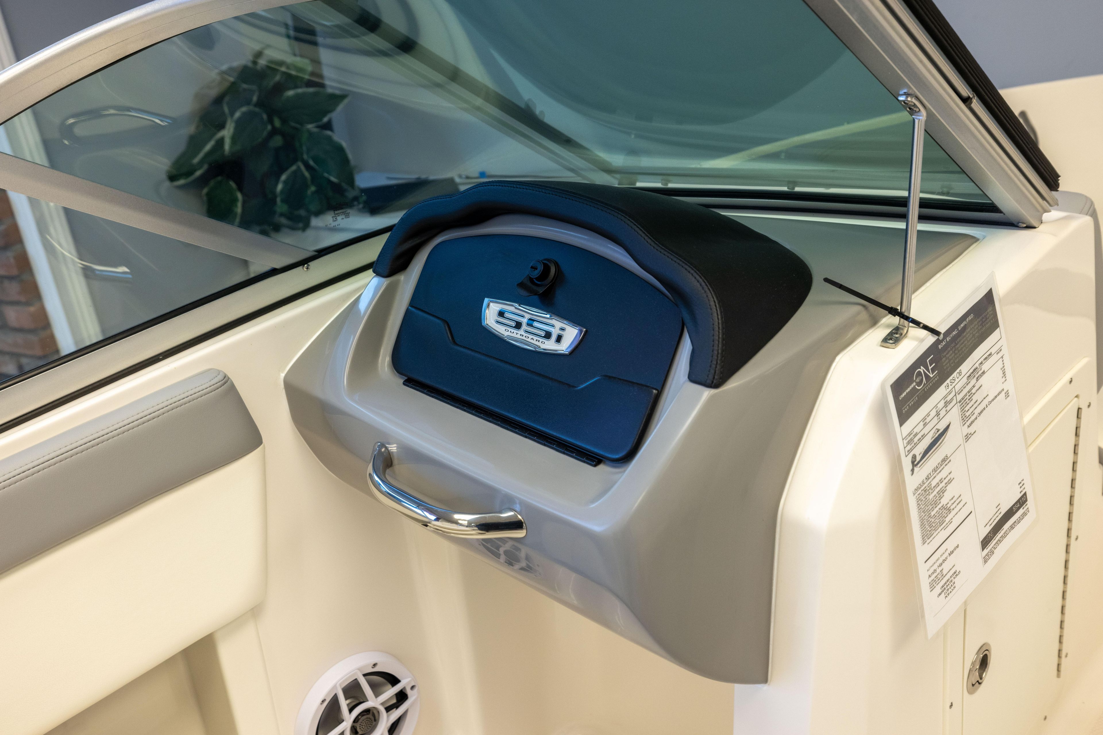 2024 Chaparral 19 SSi OB boat dashboard with glove compartment and speaker.