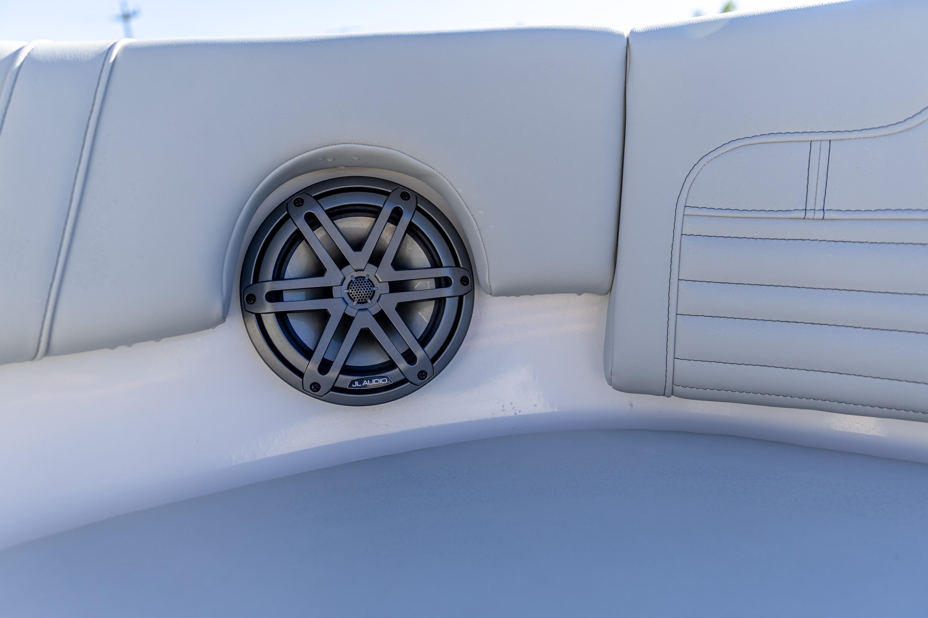 Speaker on 2025 Edgewater 248CX Crossover boat with white cushioned seating.
