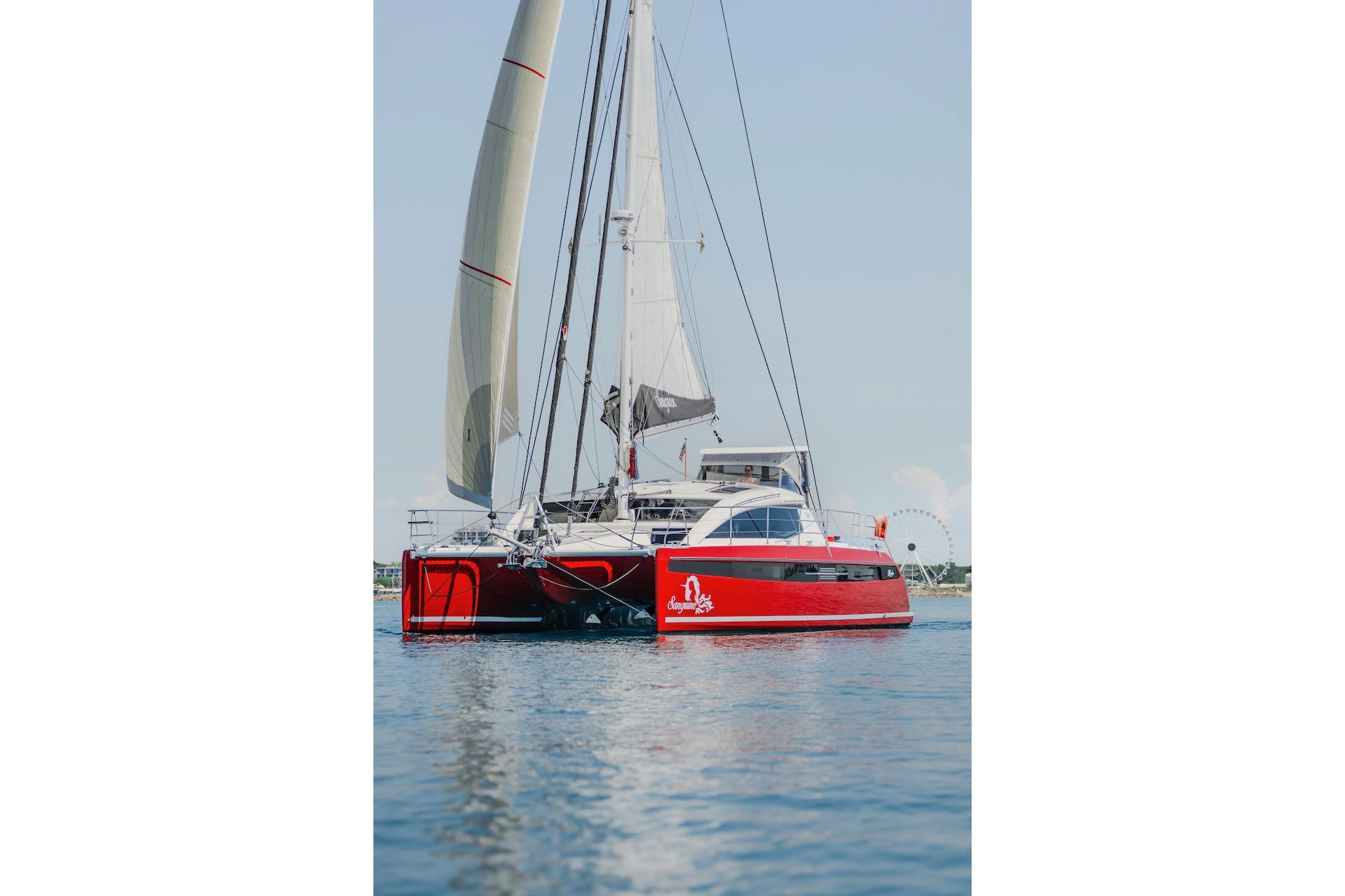 Red Privilege Signature 510 catamaran on calm water, year 2025.