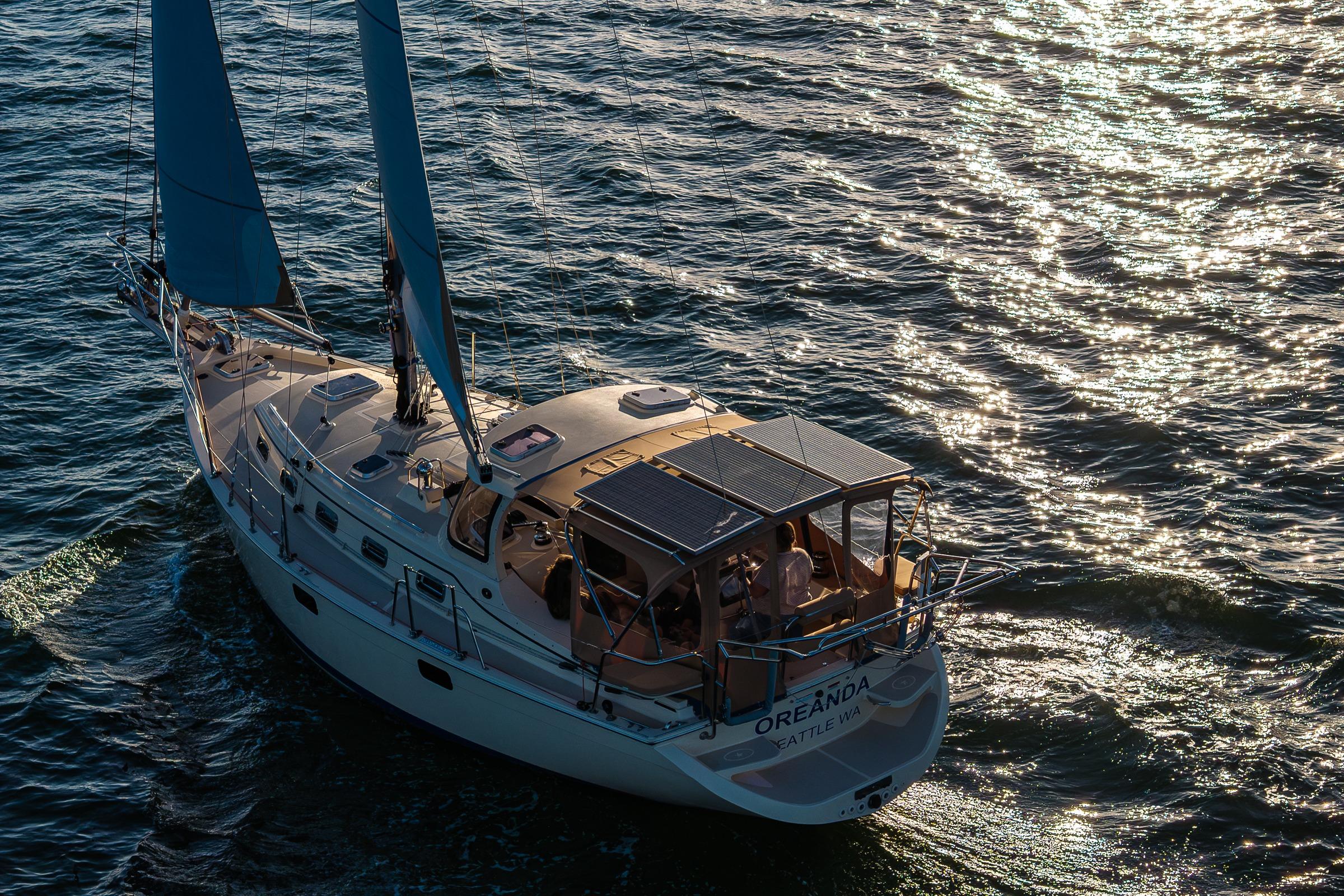 Sailing yacht Island Packet 349, 2020 model, gliding on sunlit waters.