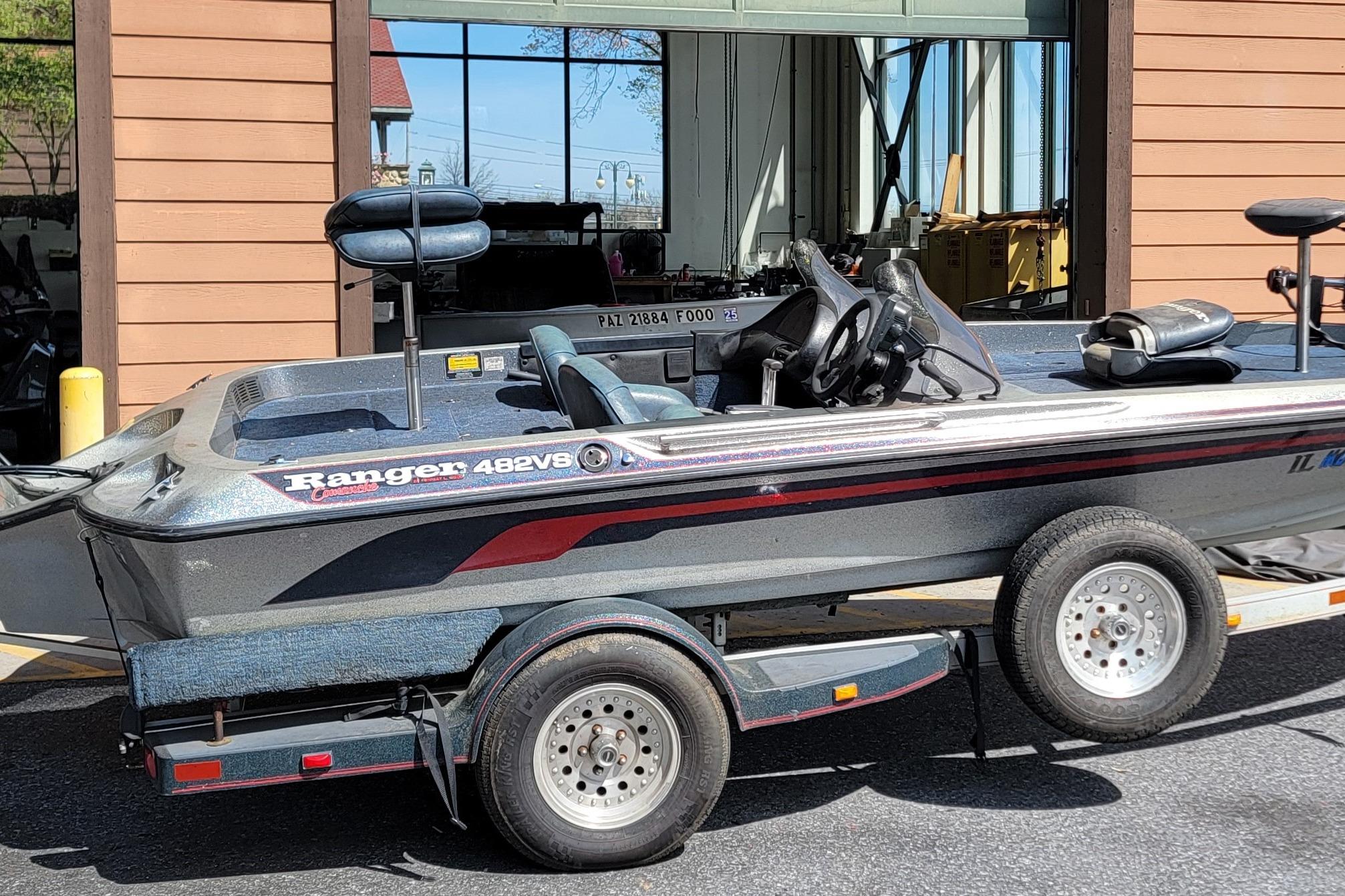 1995 Ranger boat on trailer, parked outside a building.