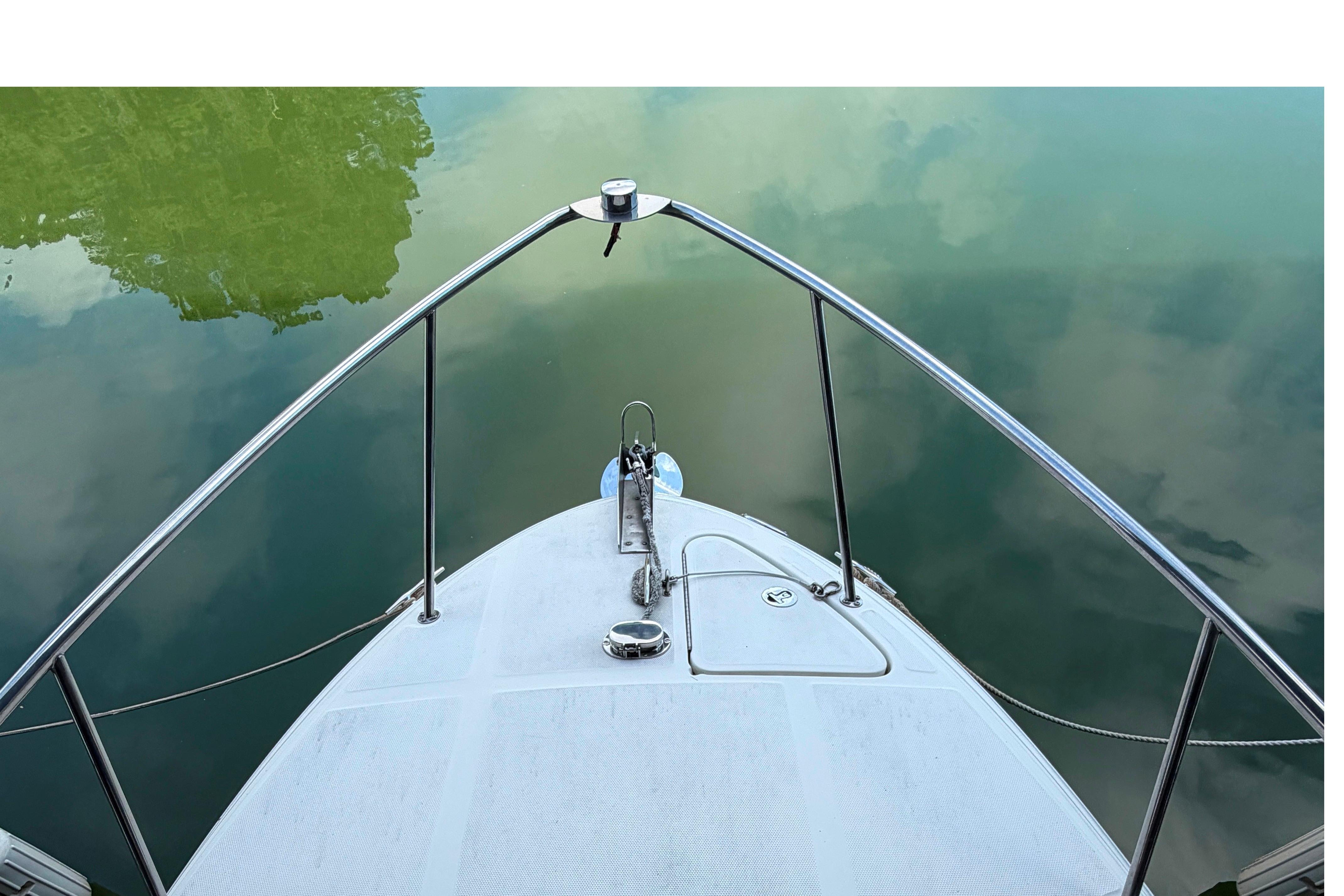 Bow view of 2004 Sea Ray Sundancer 260 on calm water.