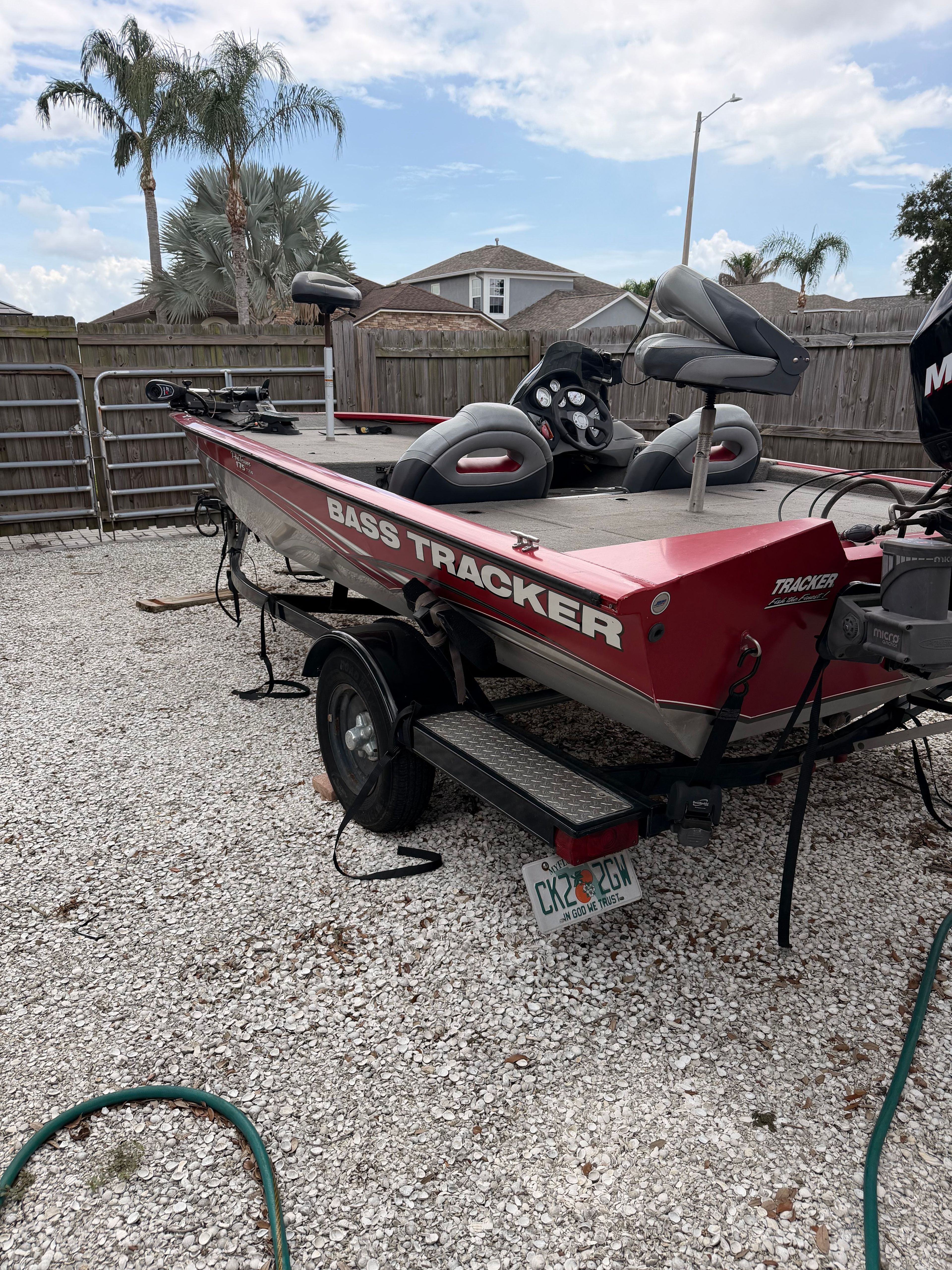 2011 Bass Tracker PRO TEAM 175 TXW on a trailer in a yard.