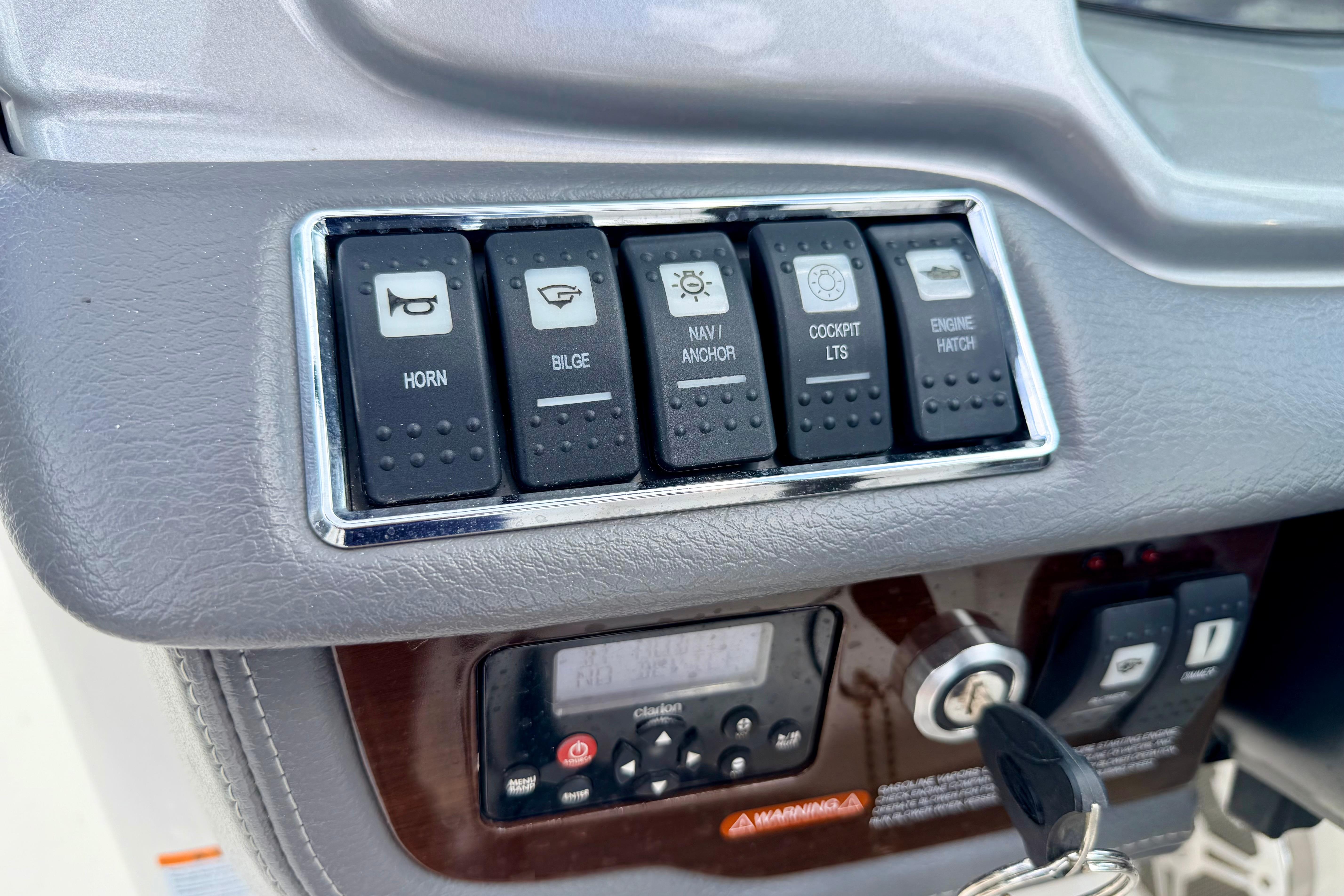 Control panel of a 2015 Chaparral Sunesta 264 boat with labeled switches and ignition.