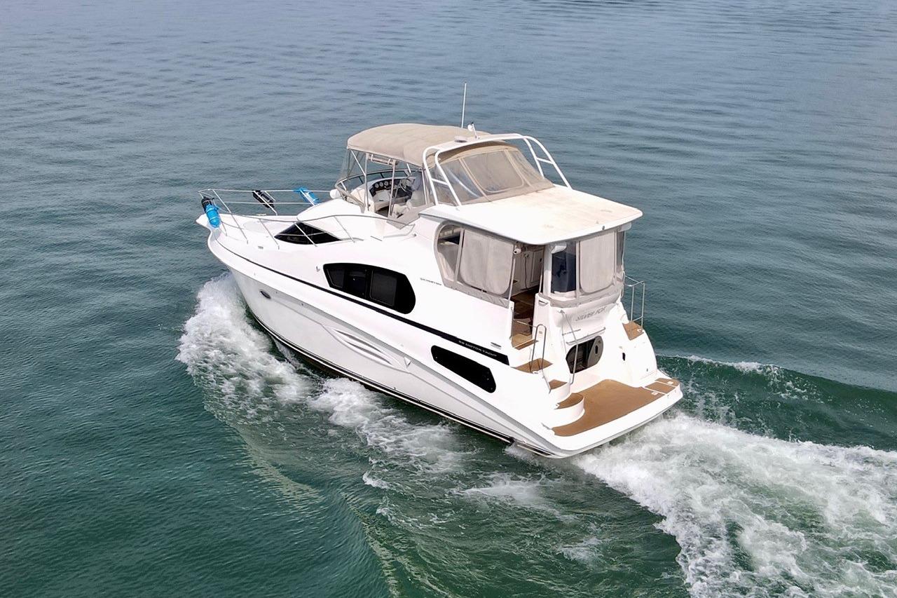2004 Silverton 39 Motor Yacht cruising on calm waters.