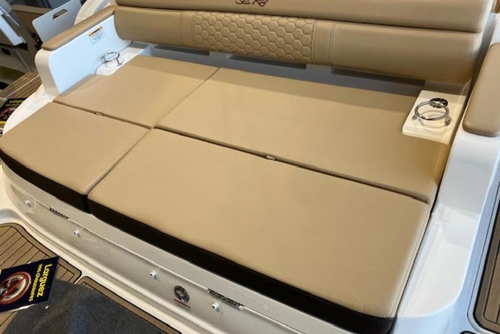 2024 Searay SDX290 boat with beige cushioned seating and cup holders.
