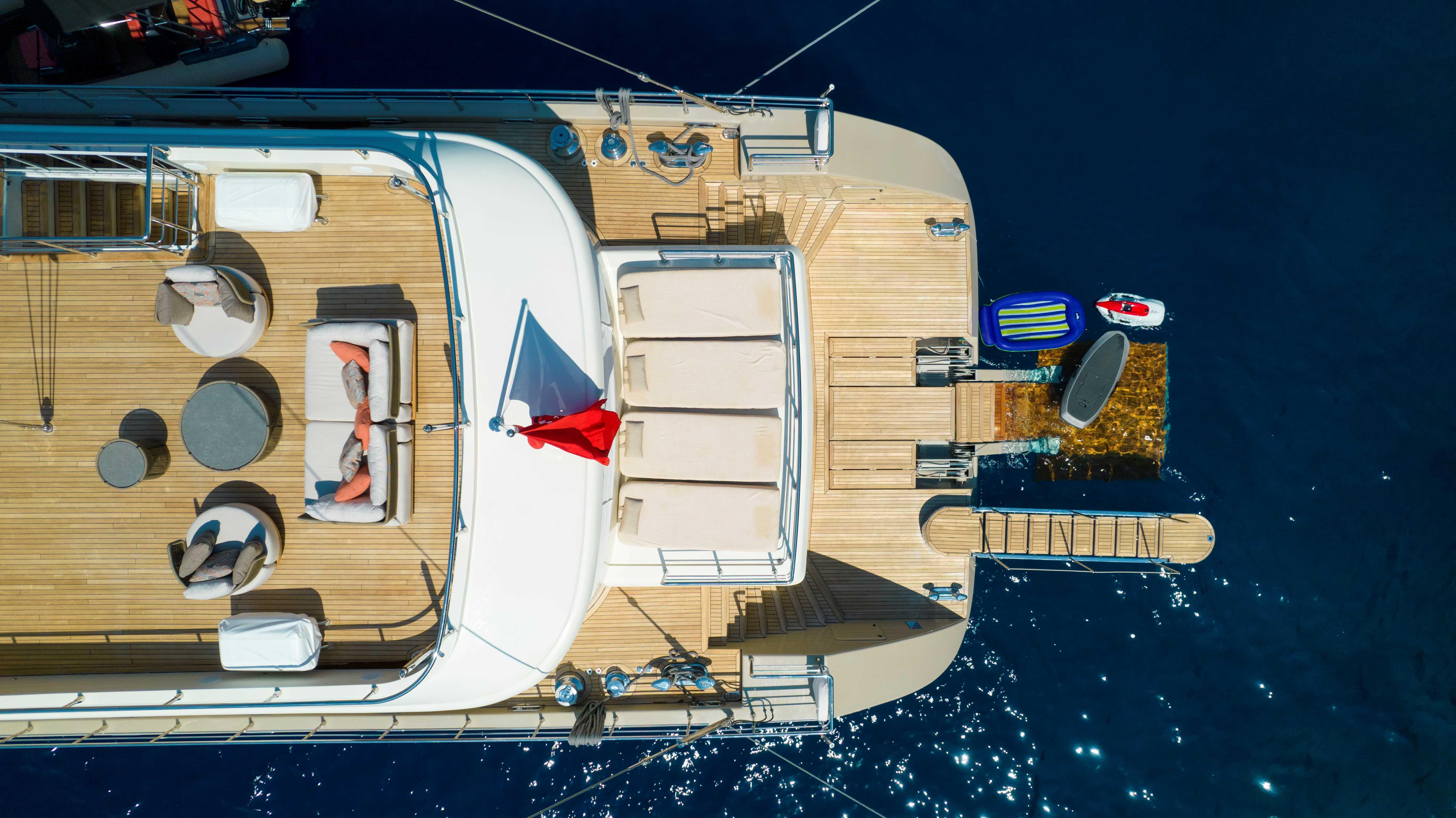 Aerial view of 2023 Custom Motorsailer 41M yacht with sun deck and water sports gear.