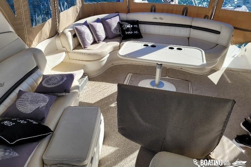 Luxurious interior of 2005 Sea Ray 500 Sundancer yacht with plush seating and table.