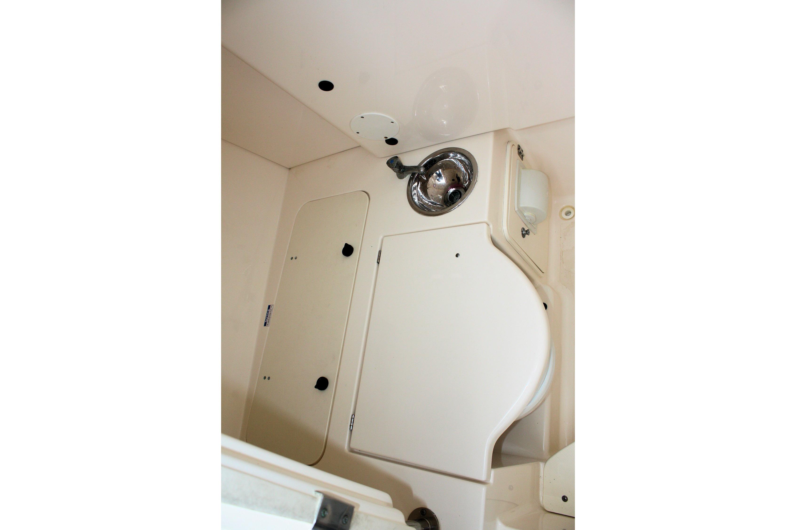 2013 Pursuit ST 310 Sport boat interior with sink and storage compartments.