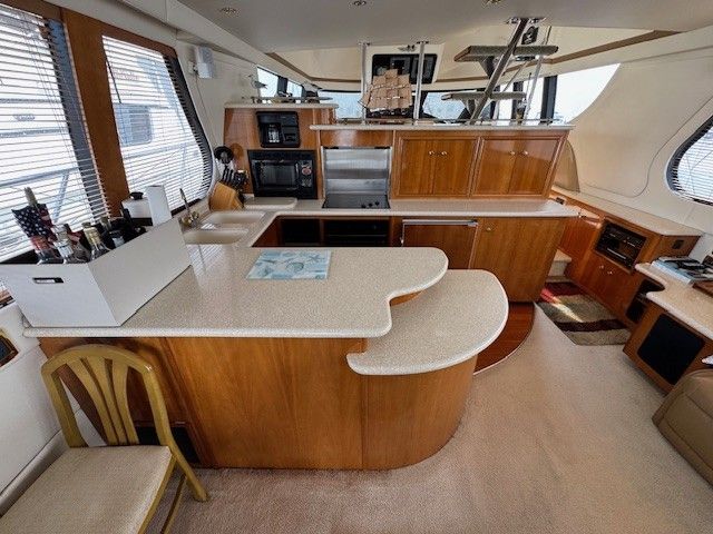 Interior of Carver 570 Voyager Pilothouse yacht, kitchen with wood finish, 2002 model.