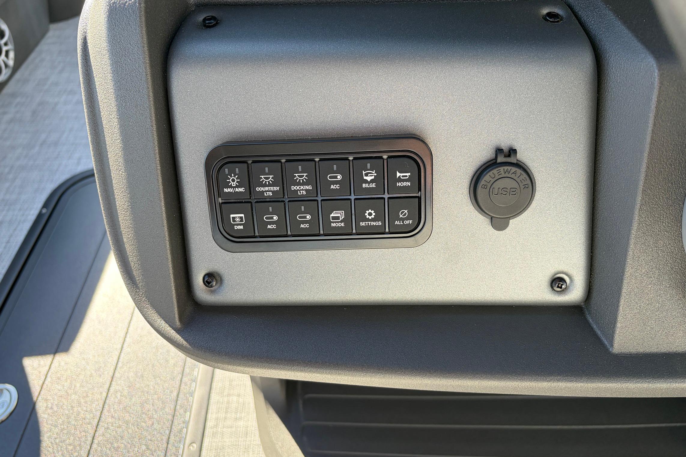 Control panel of 2026 Sun Tracker Party Barge 22 RF XP3 with USB port and switches.
