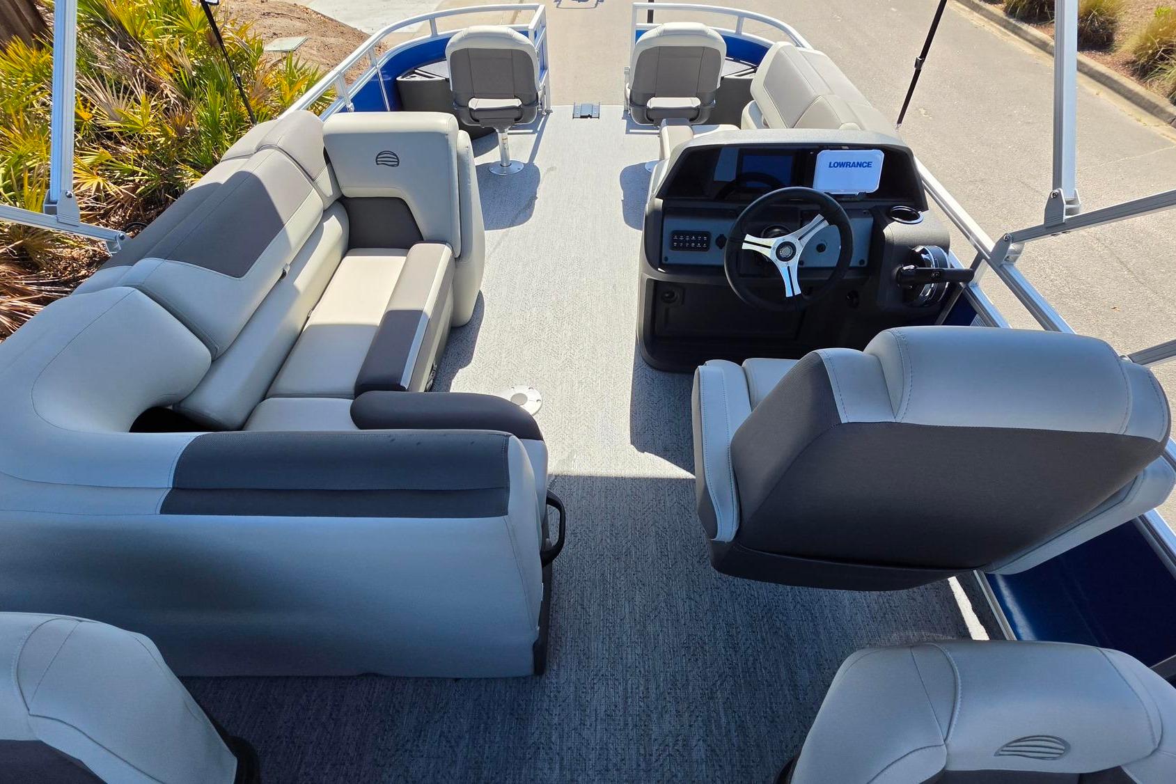 2026 Sun Tracker Fishin' Barge 20 DLX interior with plush seating and modern helm.