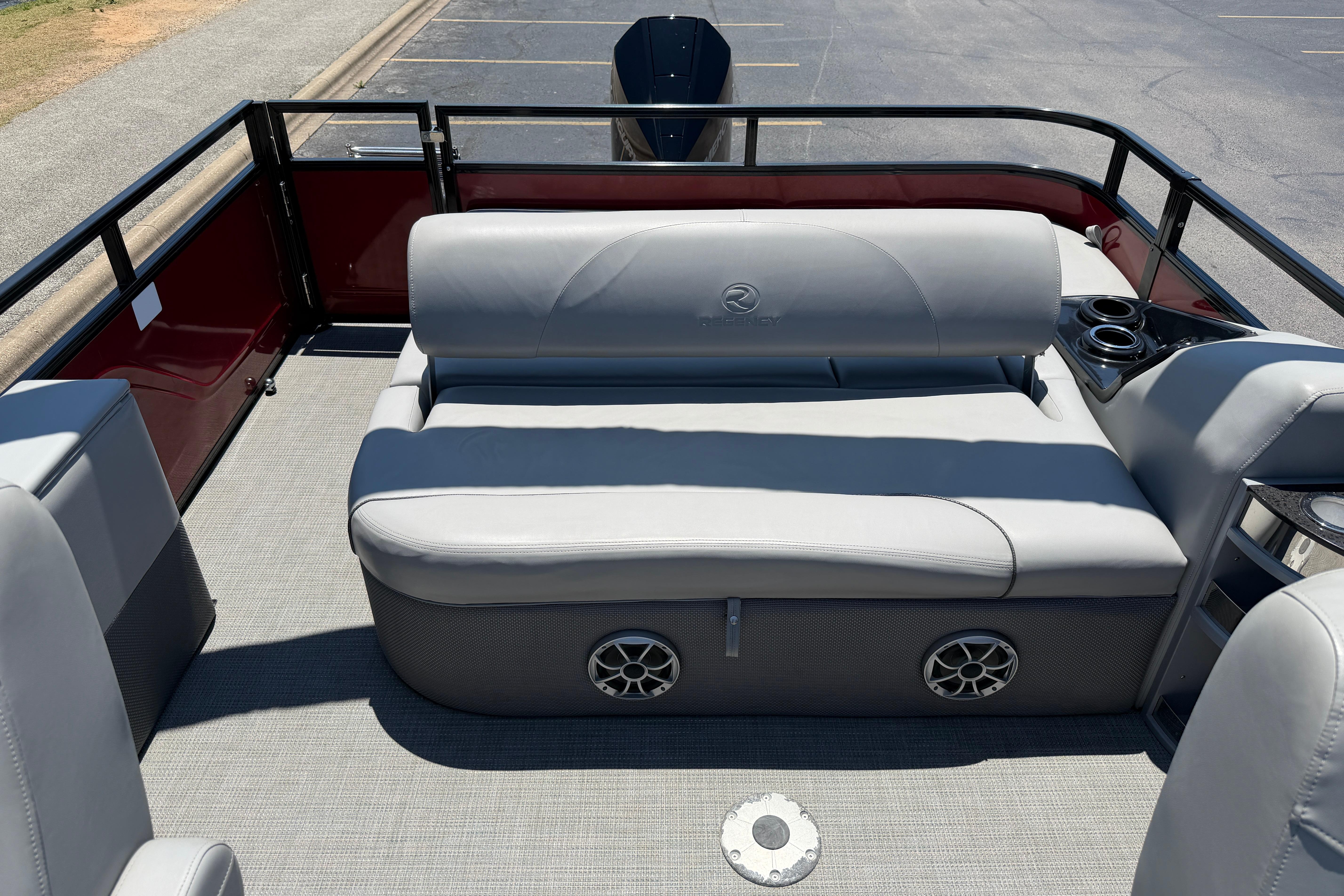 2024 Regency R250DL3 pontoon boat interior with gray seating and cup holders.