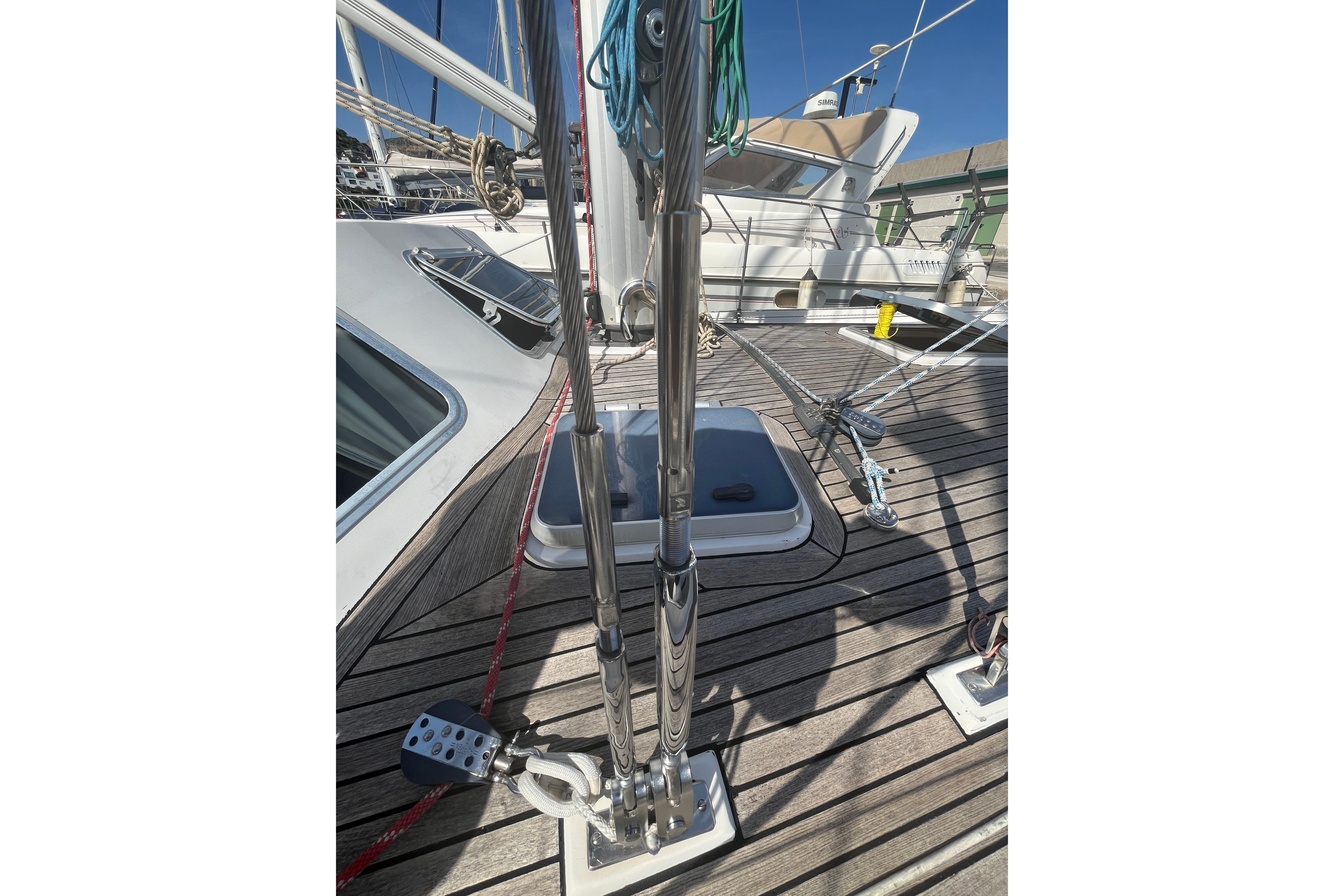 Deck view of 1995 Belliure 41 sailboat with polished fittings and wooden finish.