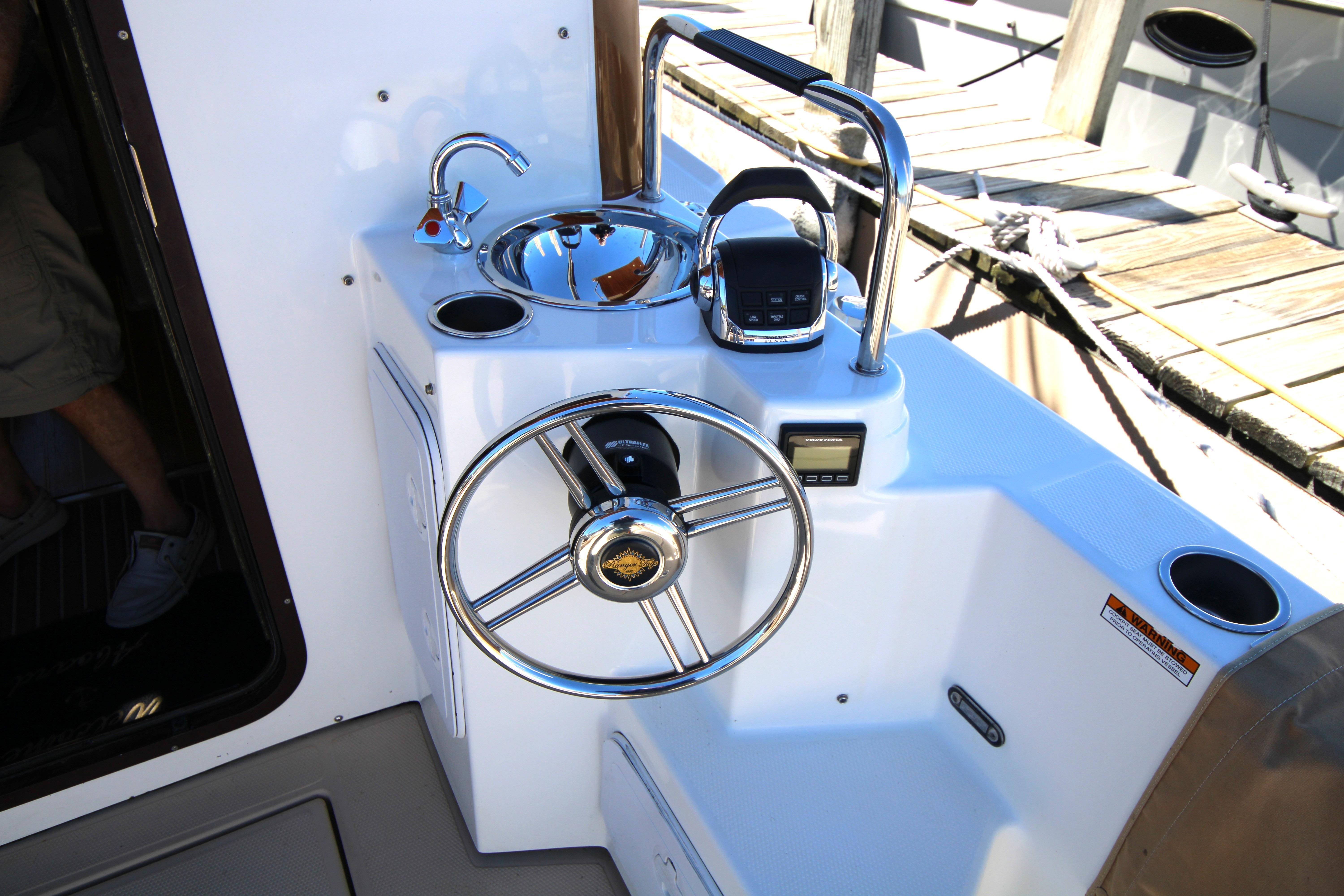 2013 Ranger Tugs R-31 CB helm station with steering wheel and controls.