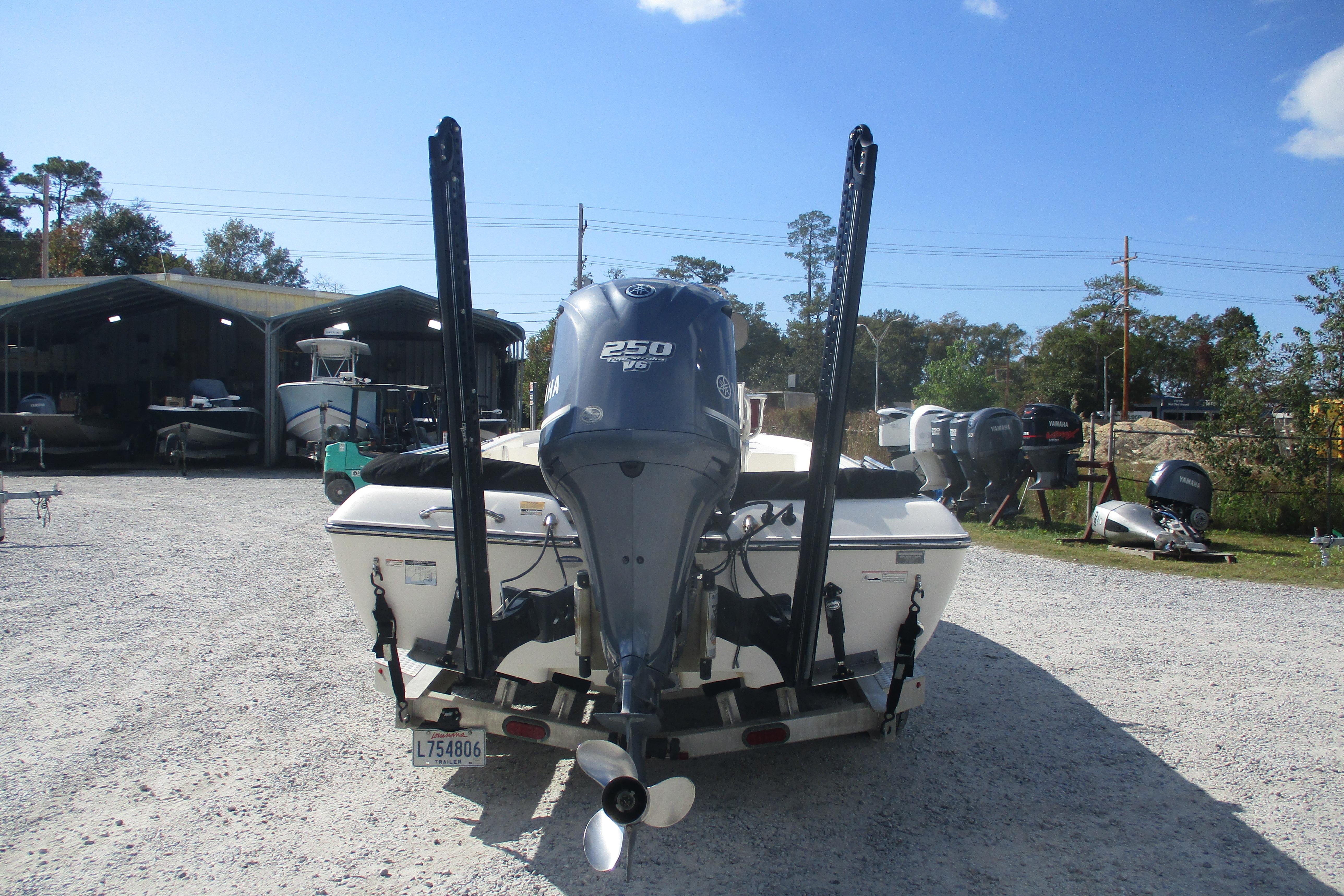 2014 Skeeter SX240 boat with Yamaha 250 V6 engine, parked outdoors.