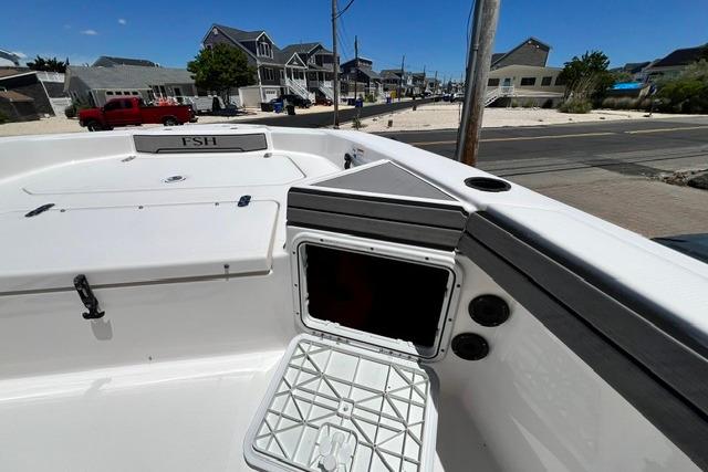 2019 Yamaha Boats 190 FSH Sport, open storage compartment, docked in a residential area.