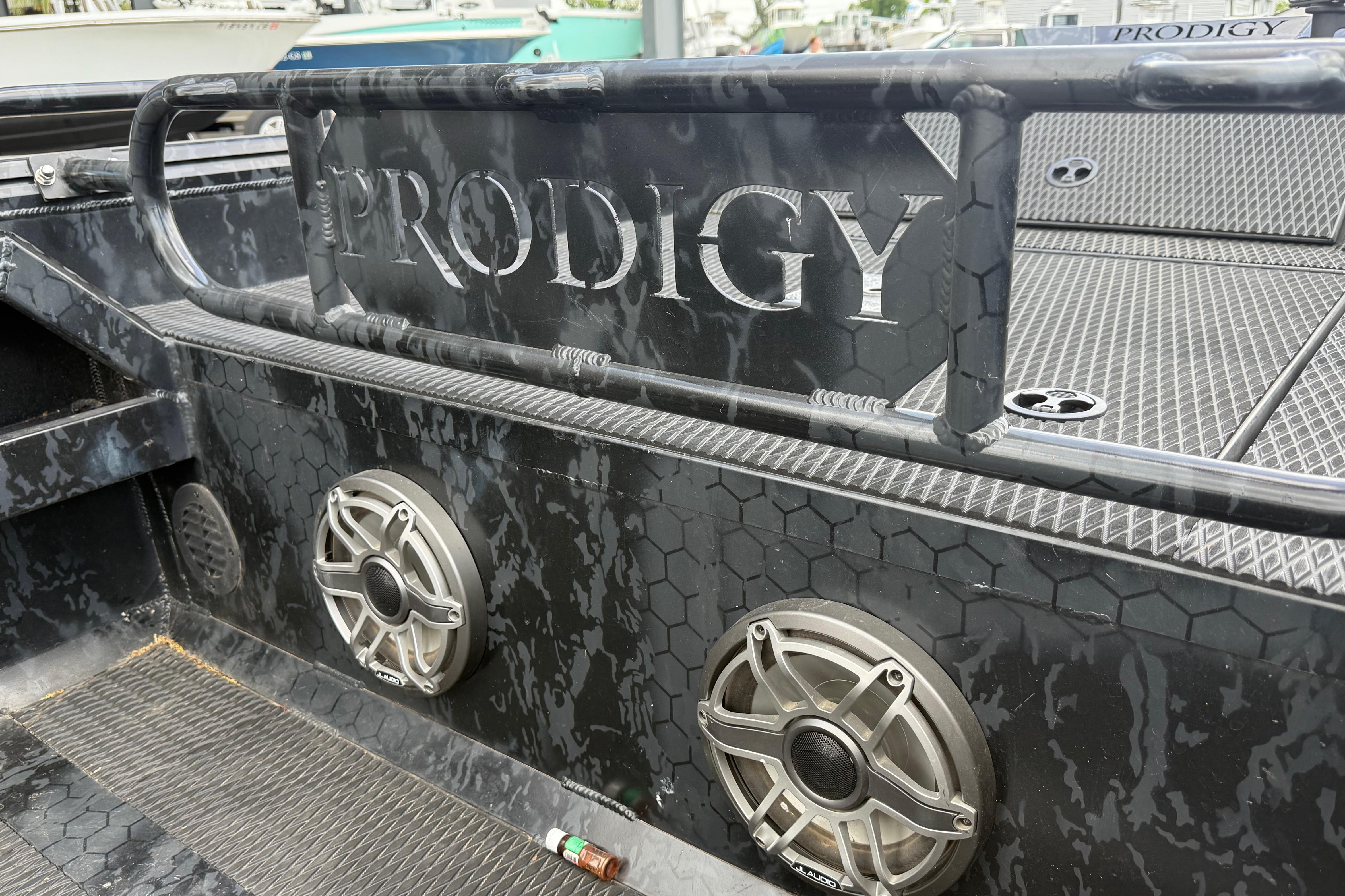 2024 Prodigy 17 boat interior with speakers and textured flooring.