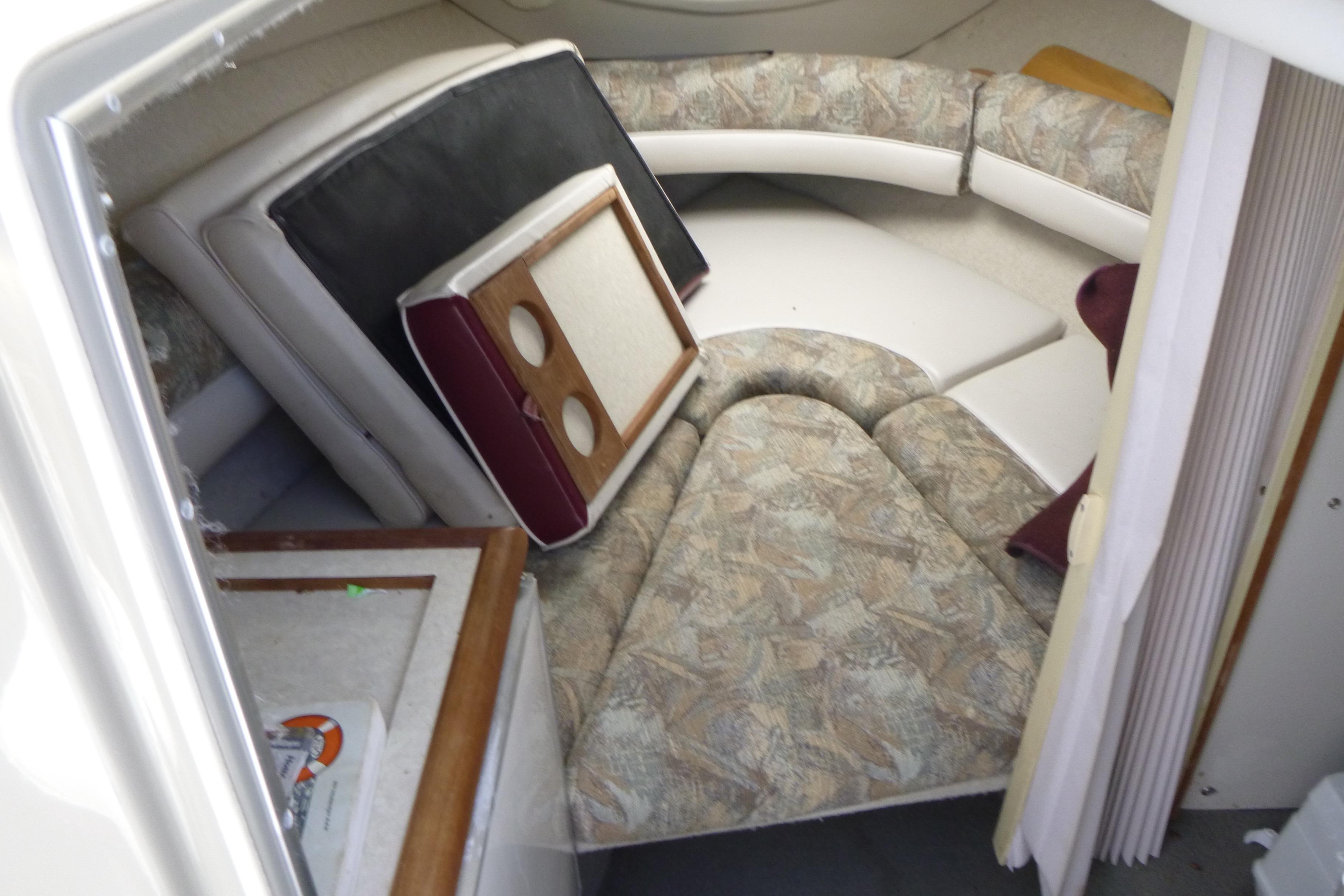 1998 Maxum 2300 SC cabin interior with cushions and table setup.
