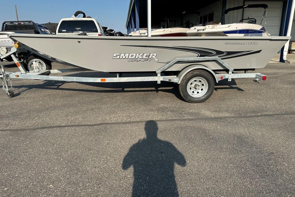 2025 Smoker Craft Sportsman 1660 boat on trailer, parked outdoors.