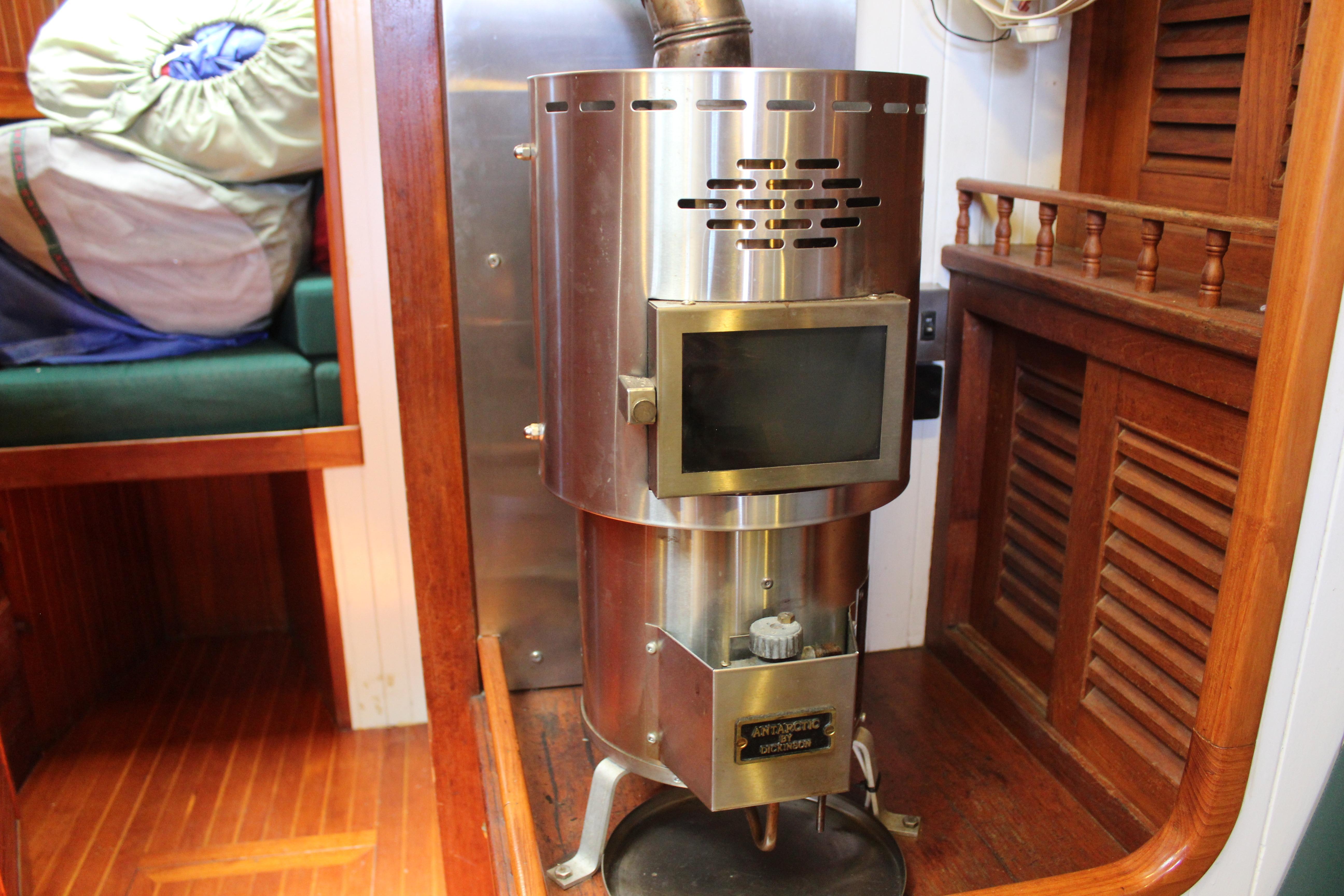 Stainless steel heater inside 1981 Kelly Peterson 46 sailboat cabin, with wooden interior accents.